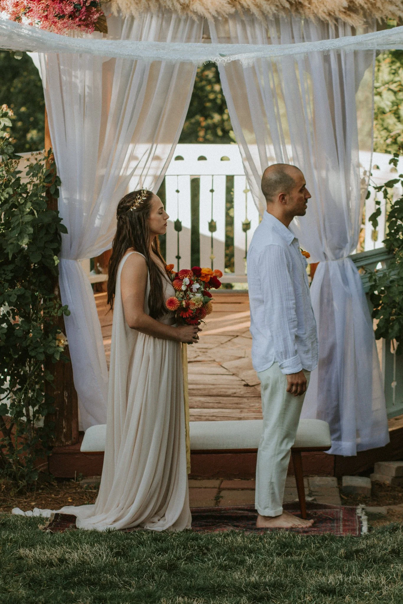 wedding day - couple under their arch