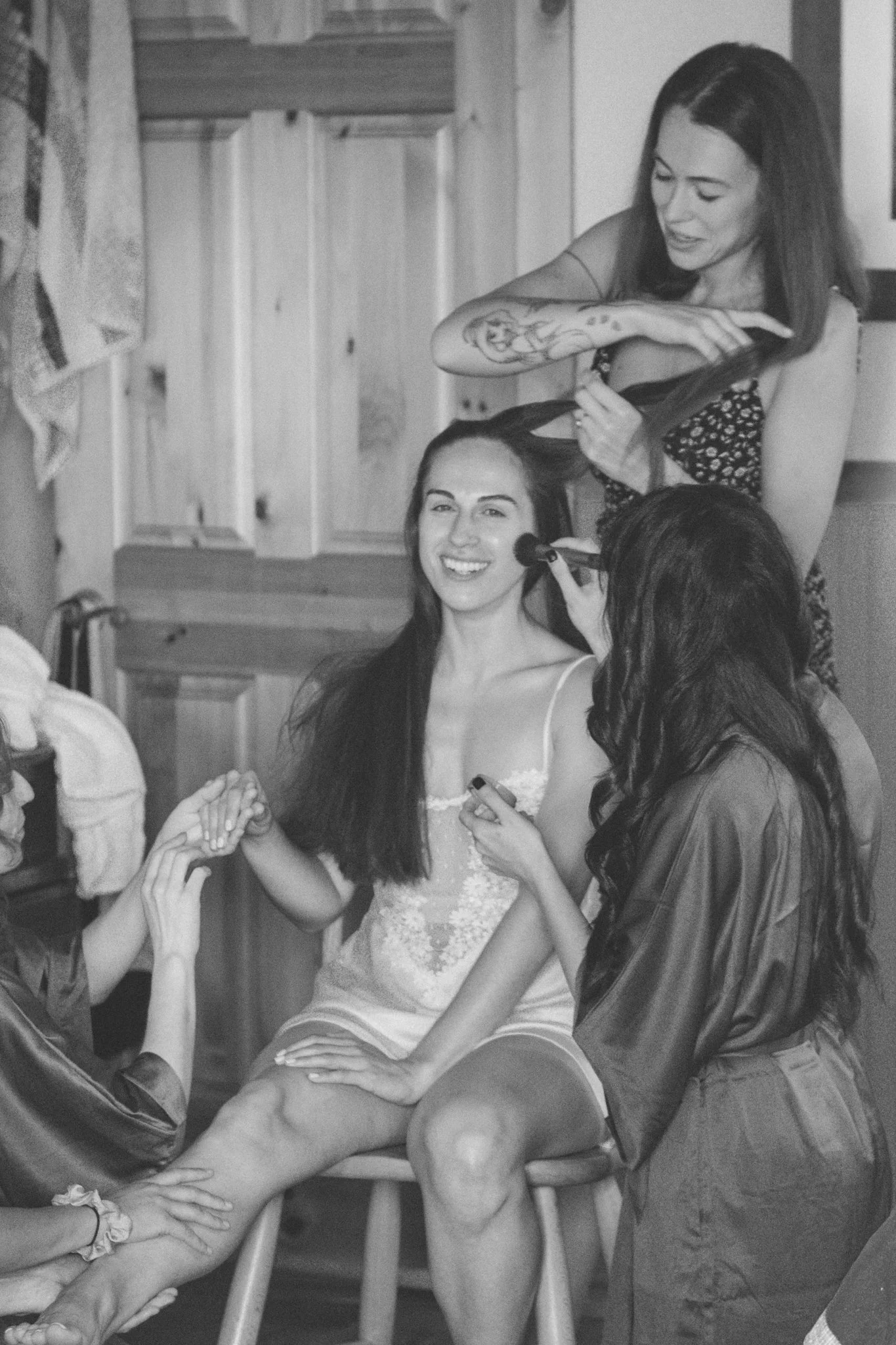 wedding day - the bride is getting ready with her bridesmaids pampering her. doing her hair, her make up and get her skin glowing 