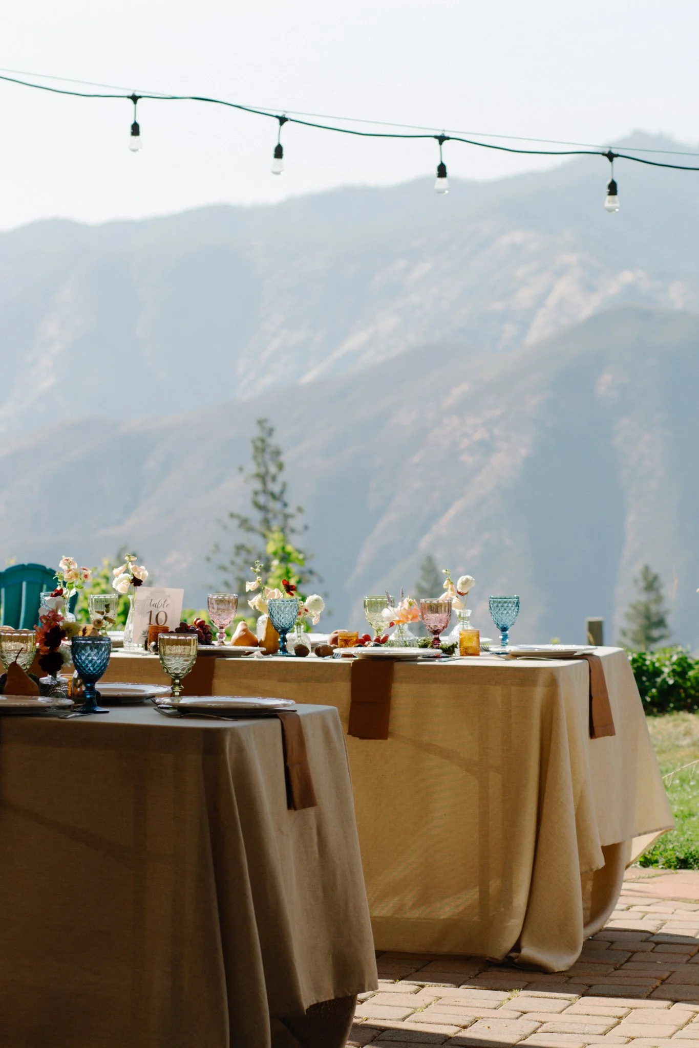 wedding day - the decoration on the table is beautifully set agains the mountains as a backdrop