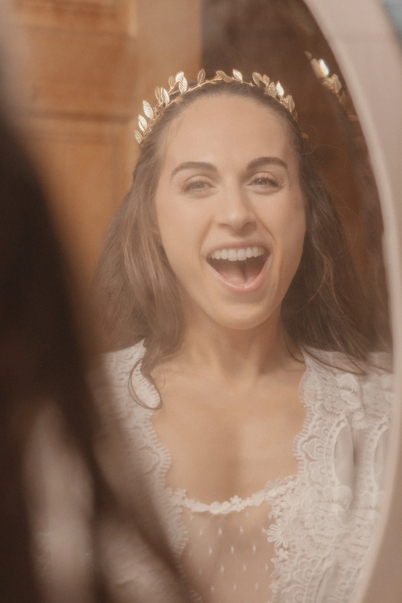 wedding day - the bride is getting ready in front of a mirror being excited