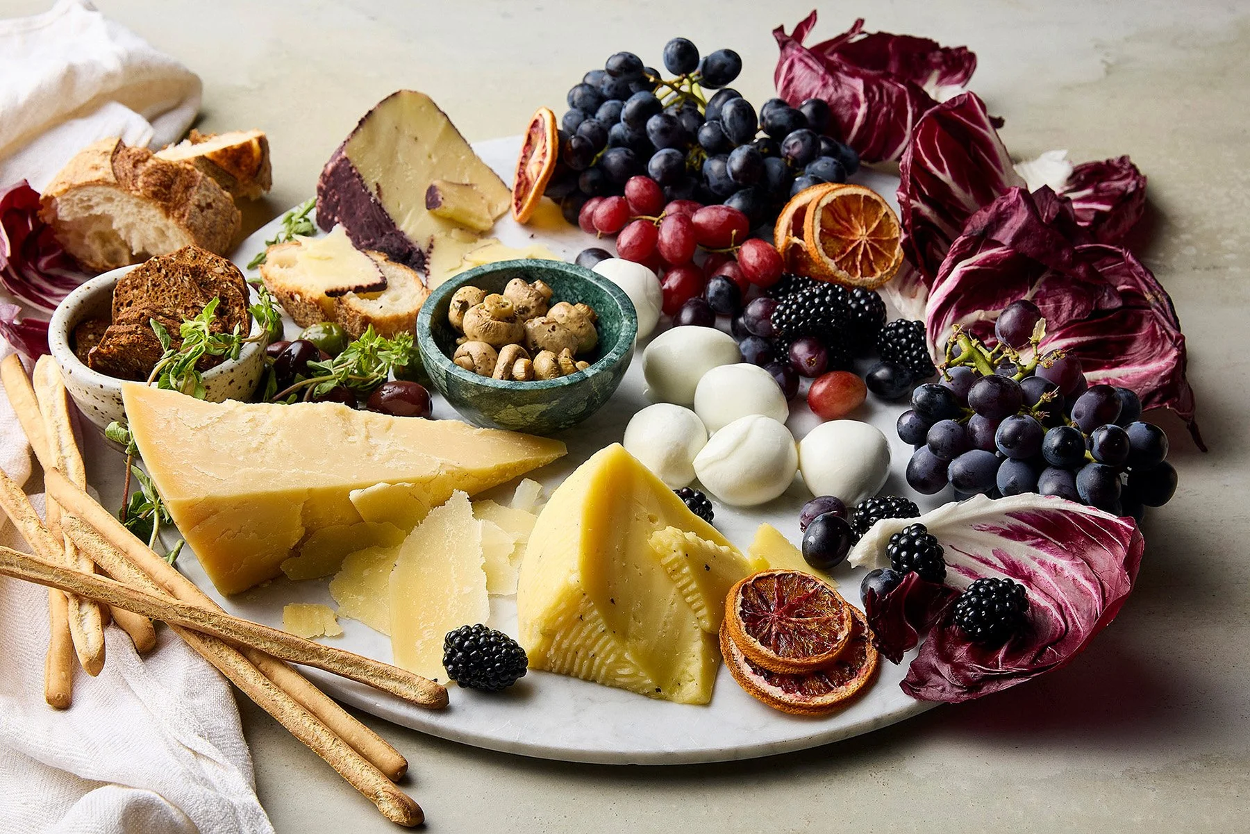 decorative cheese platter with mixed Italian cheeses, radicchio 