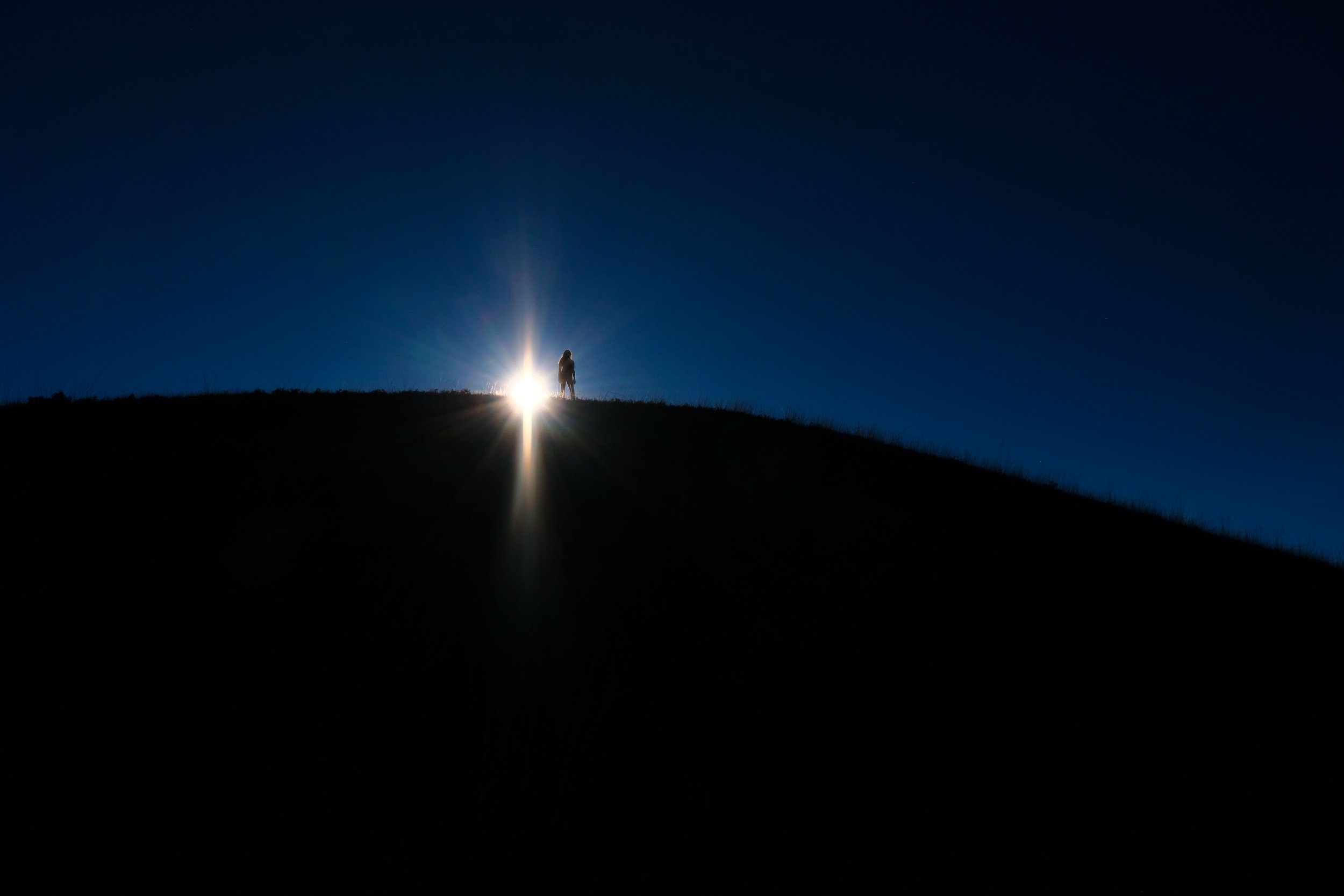 Glitter: The setting sun casting shapes behind a girl on Mount Tamalpais