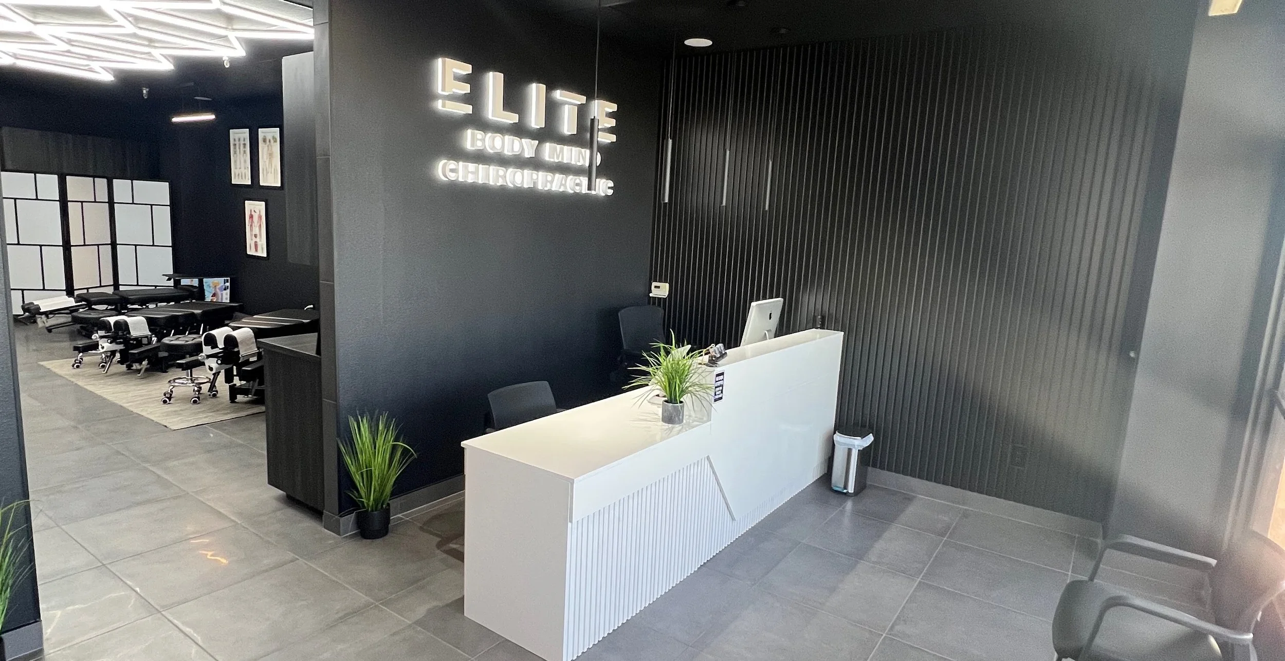 Elite Body Mind reception area with front desk. Clean and minimal aesthetic.