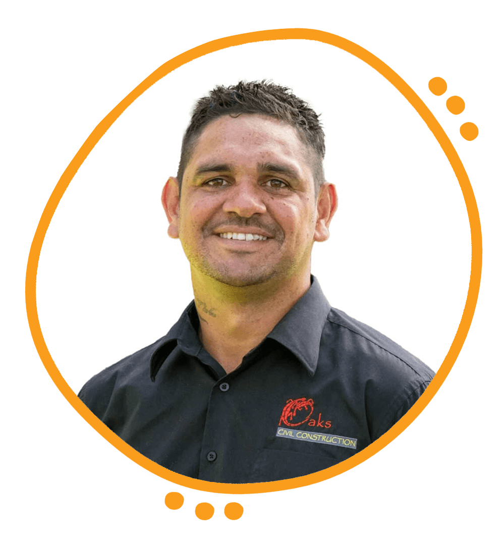 A man smiling, wearing a black polo shirt with a red and yellow logo and the words 'Oaks Civil Construction' on it.
