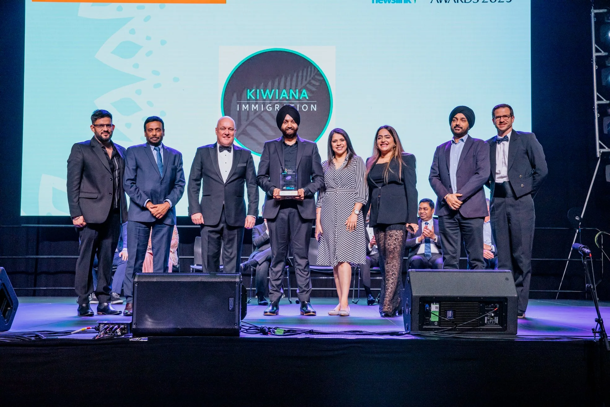 Pawandeep Singh holding the award with New Zealand Prime Minister Christopher Luxon