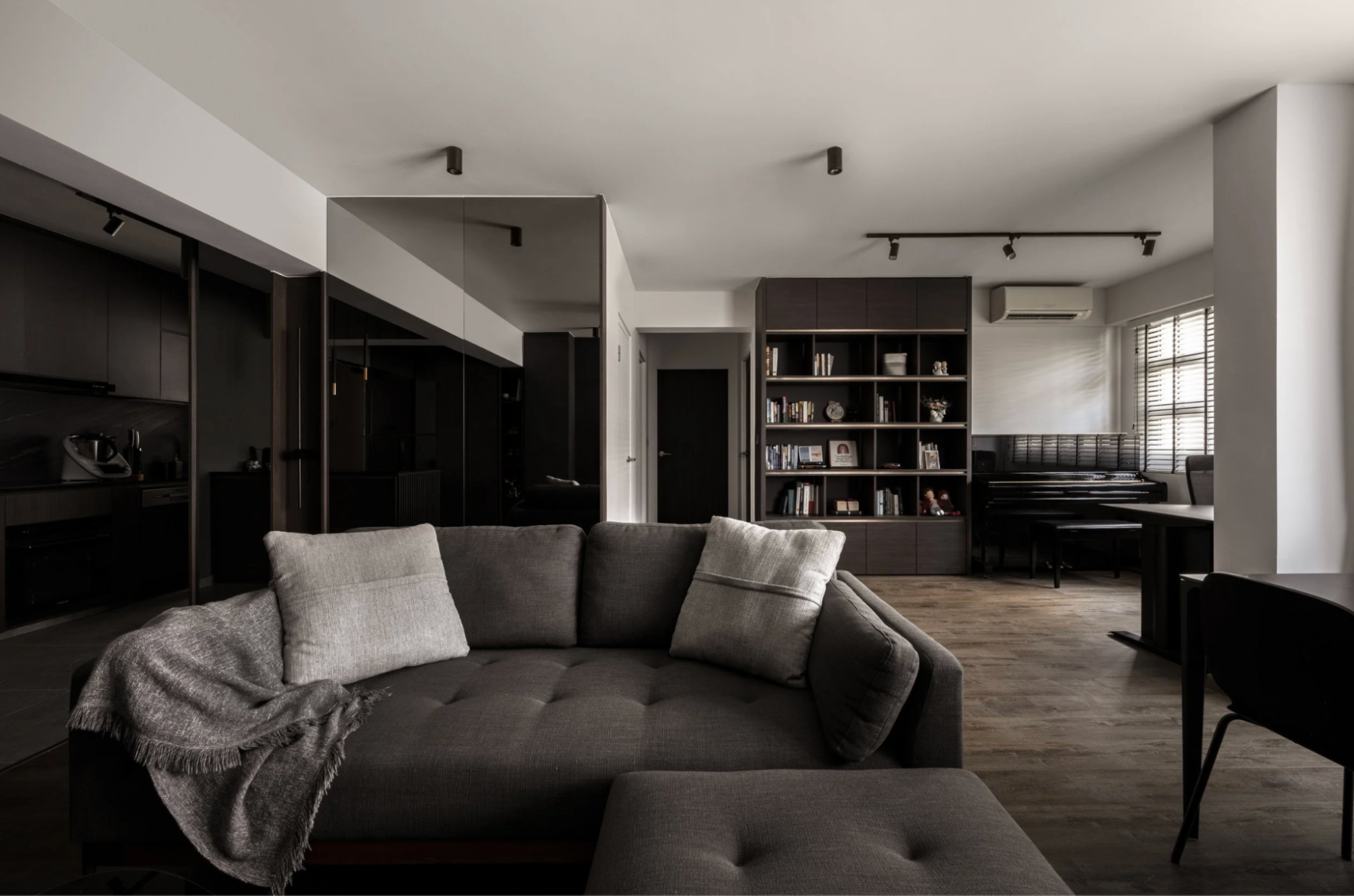 Dark, moody contemporary interior design style in a spacious living room.