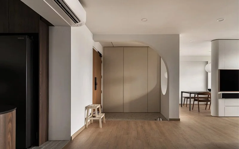 Minimalist interior with wooden floor and modern furnishings.