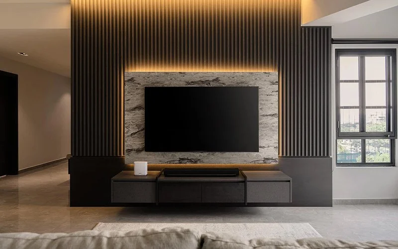 Luxury TV feature wall with marble textures and ambient lighting.