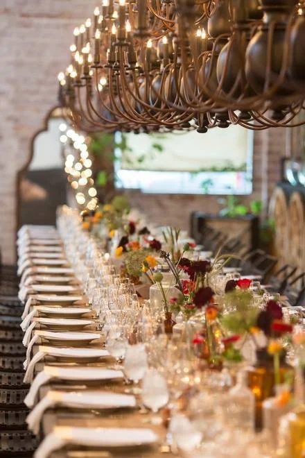 A beautiful long table laid with glasses and flowers