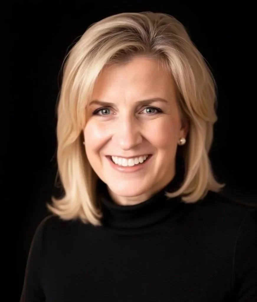Blonde woman smiling in a black turtle neck