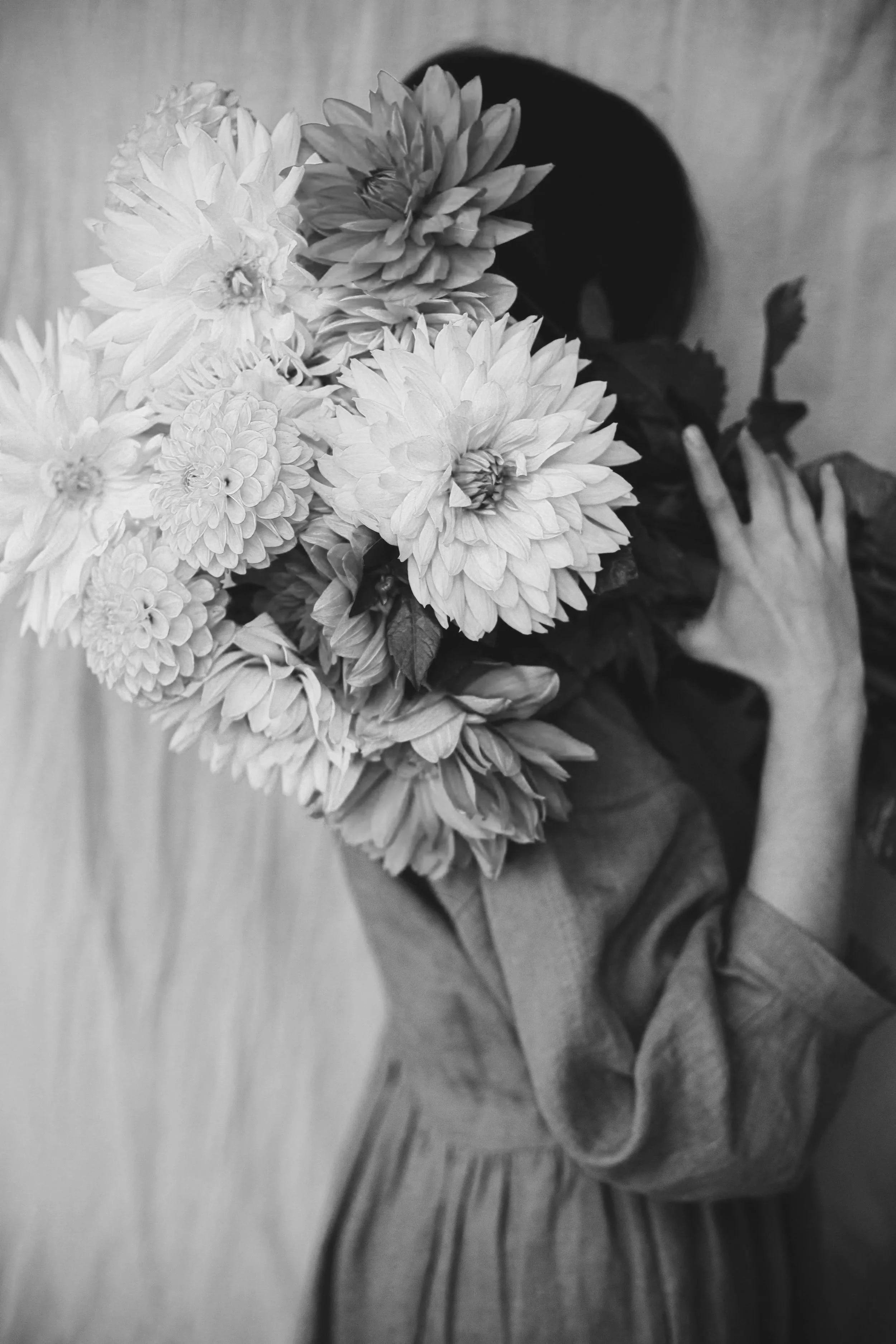 Woman holding giant bouquet of flowers