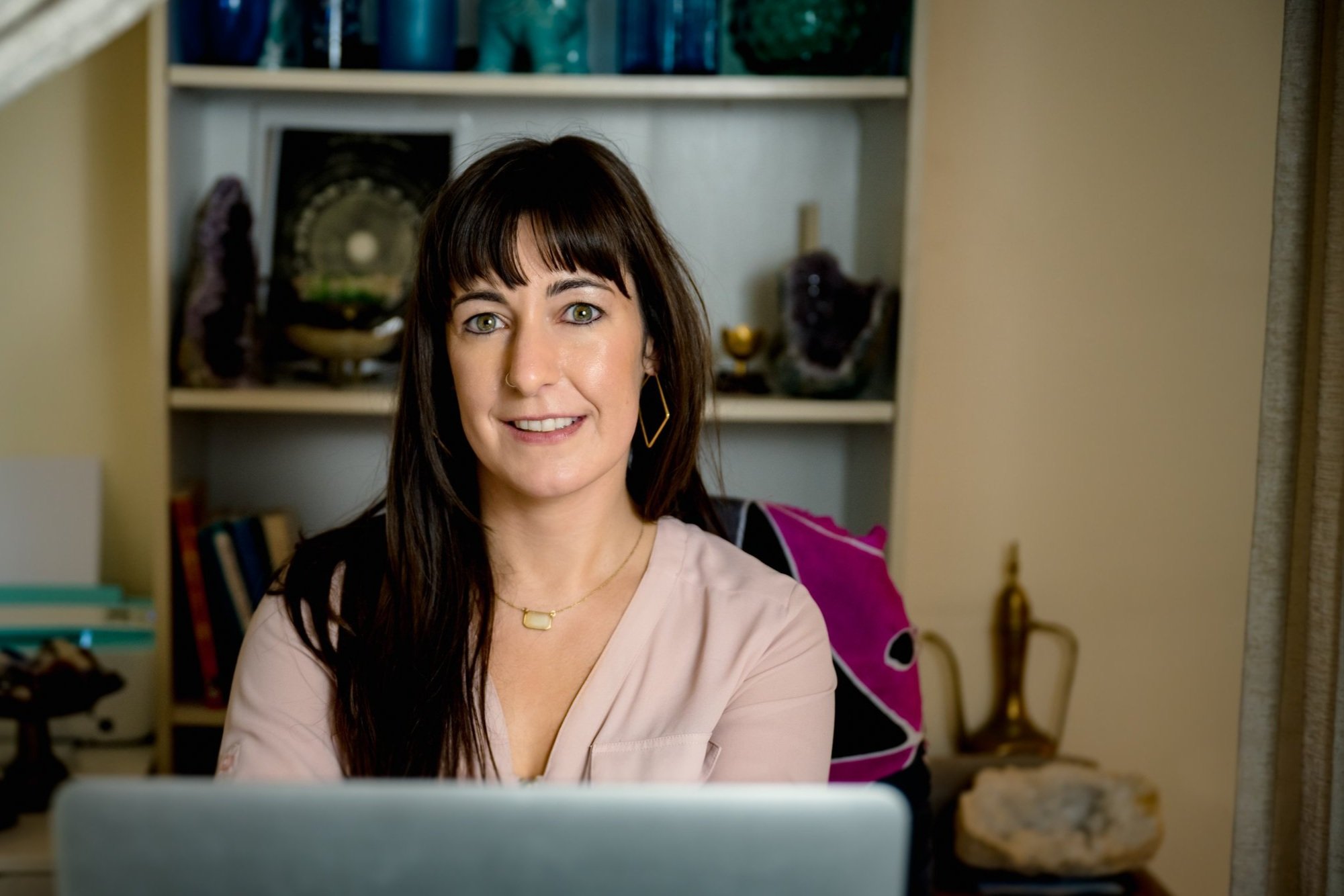 Beth, licensed psychospiritual therapist, somatic practitioner, and EMDR therapist, in her telehealth therapy office.