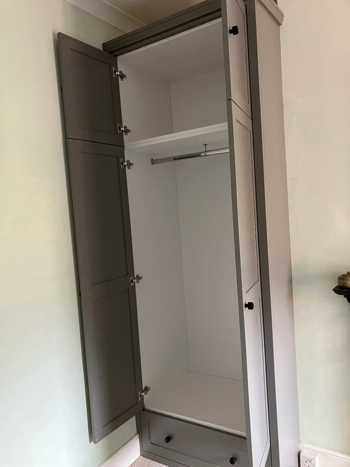 White MFC interior of a custom-made fitted wardrobe in Crouch End, London