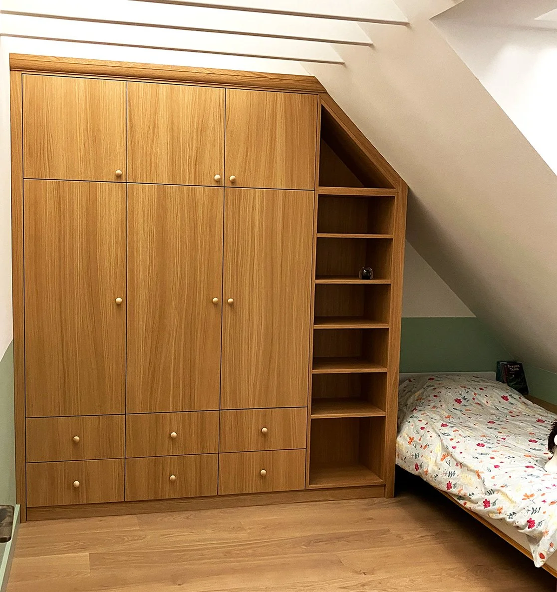 Bespoke loft bedroom wardrobe and shelves with oak surfaces and storage in Camberwell, London