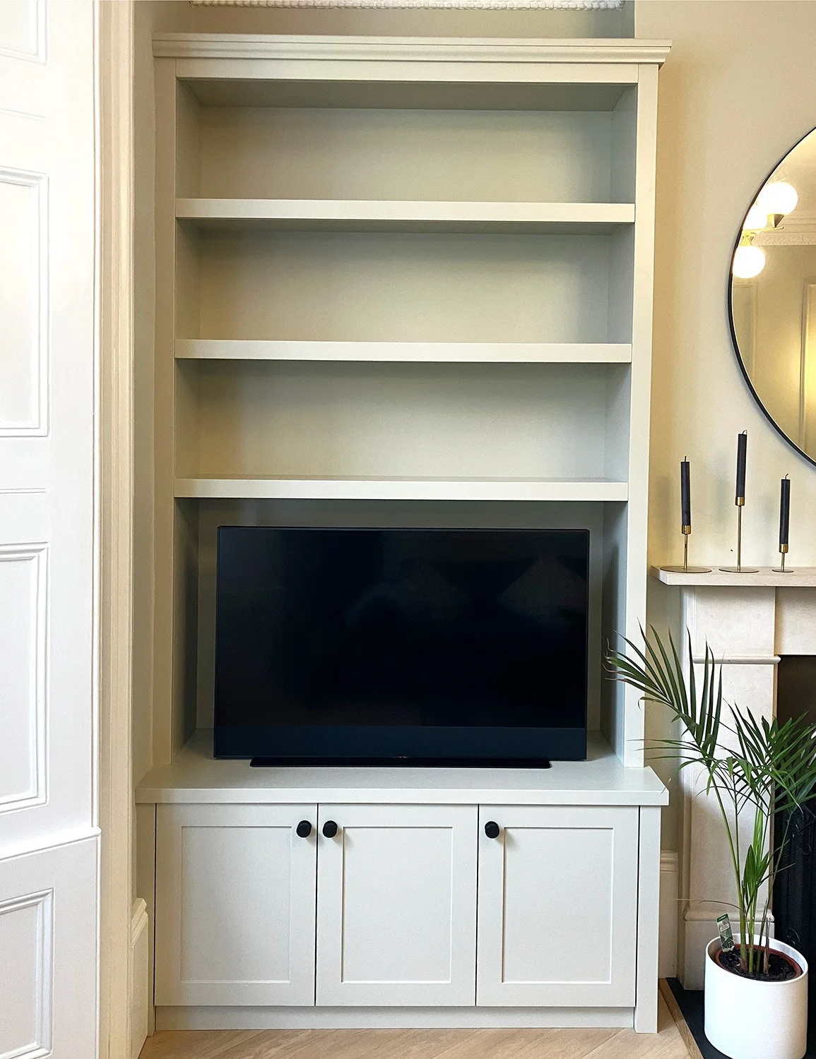 Custom alcove shelves and shaker cupboards for a TV and media equipment in Finsbury Park, London