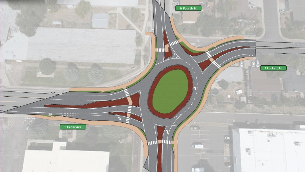 A detailed intersection diagram showing a roundabout with multiple lanes, crosswalks, and directional arrows, surrounded by labeled streets including N Fourth St, E Cedar Ave, and E Lockett Rd.