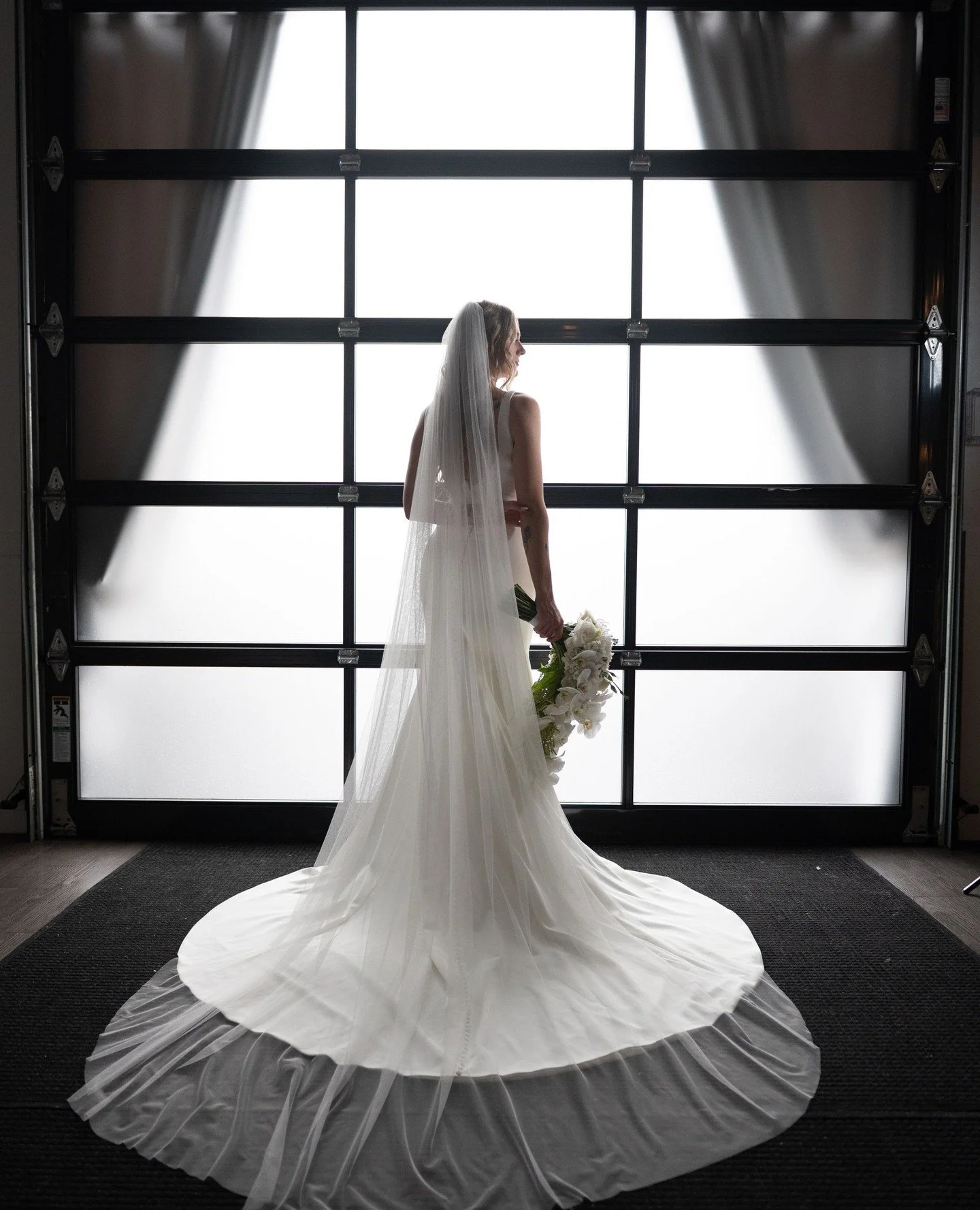where industrial meets &ldquo;i do&rdquo; ✨⁠
⁠
our signature garage doors bring in the dreamiest light for moments like this&hellip; modern, romantic, and effortlessly iconic. this is what ceremony backdrops should look like⁠
⁠
Cinematography: @roble