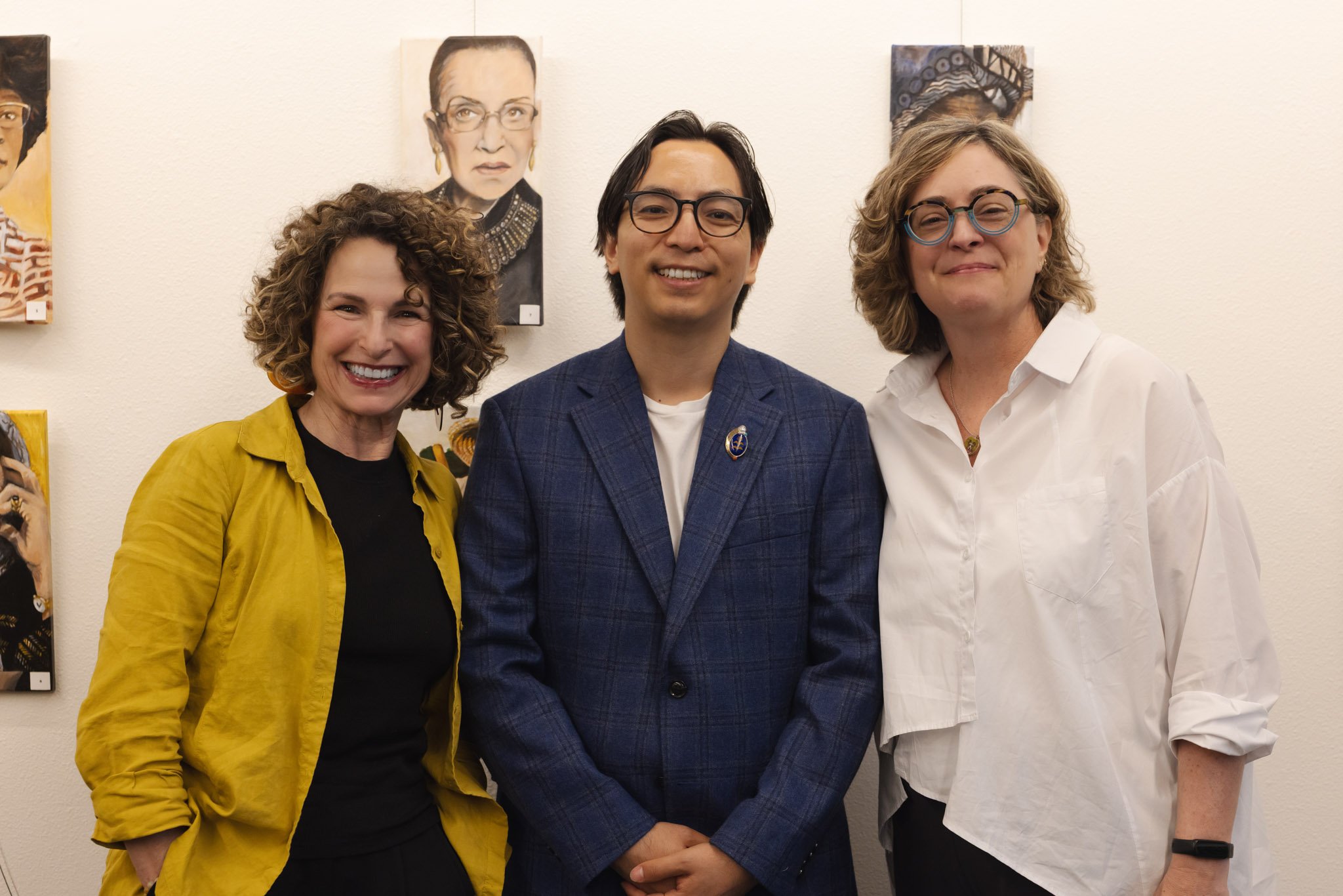 Michele Bombardier, Samyak Shertok, and Erin Malone pose for a photo at May's Open Mic event, 2026. Photo by Mandi May.