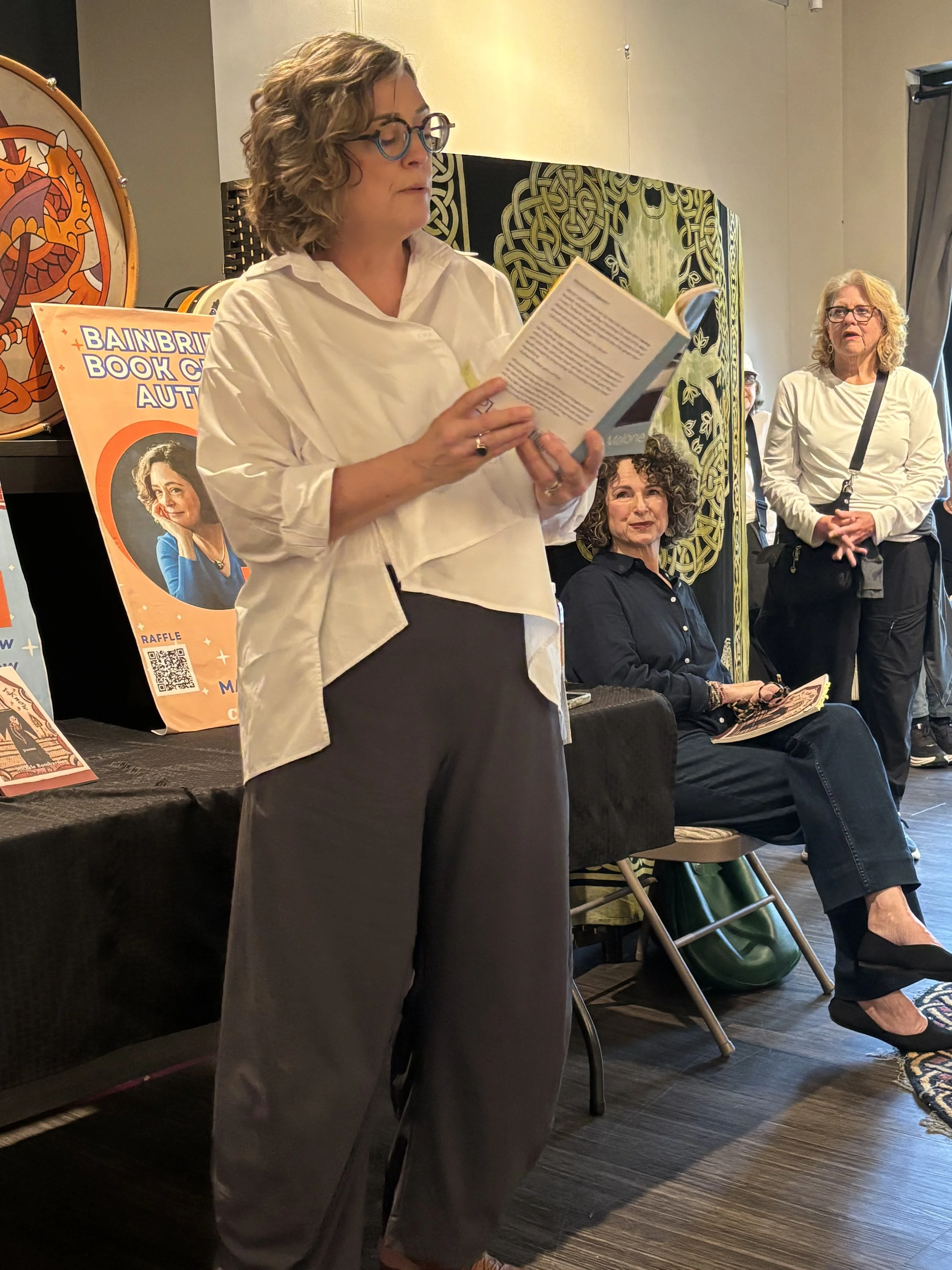 Michele Bombardier looks on as Erin Malone reads during the Bainbridge Island Book Crawl, May 28th '26.
