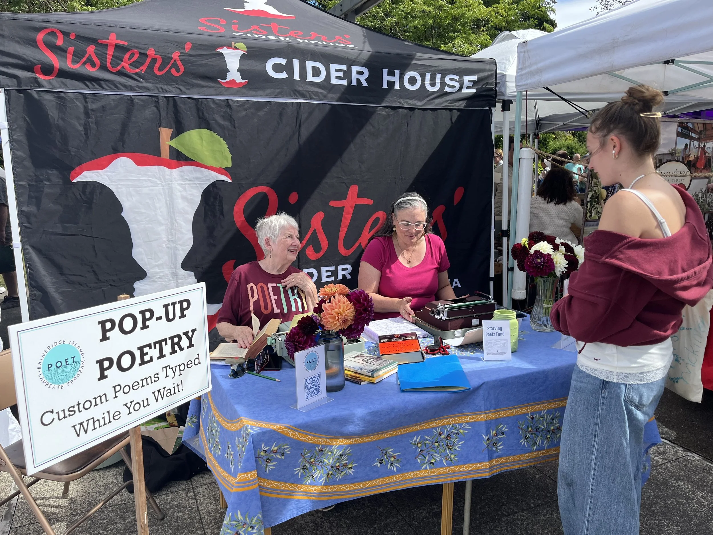 Poets Barb and Amanda represent at Saturday's Farmer's Market, creating custom poems! August 1, 2026