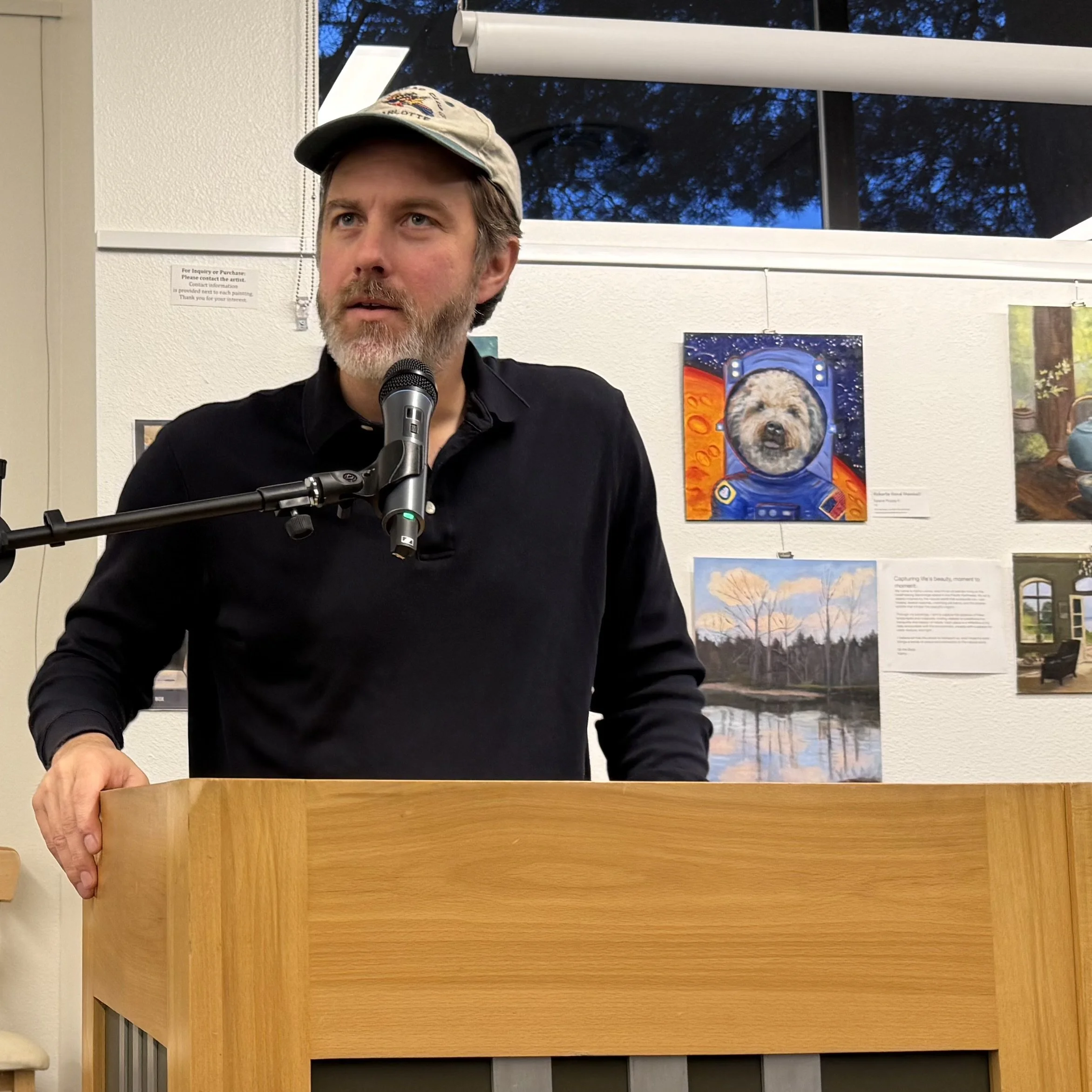 Guest reader Bill Carty reads at March's Open Mic, March 2026.