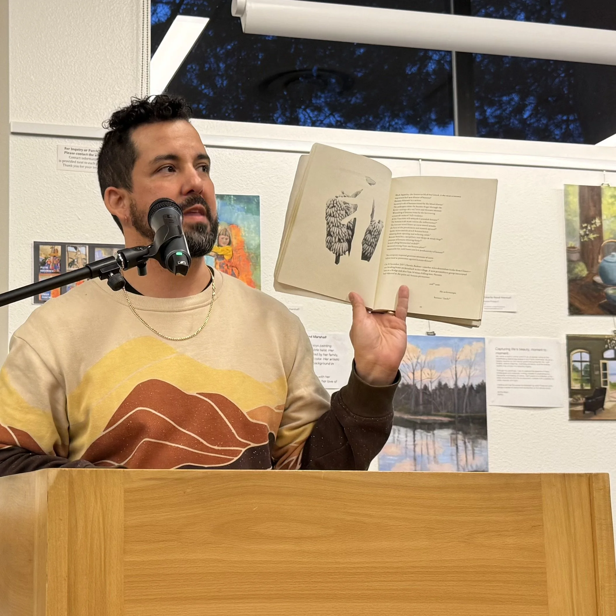 Guest reader Paul Hlava Ceballos reads at March's Open Mic, March 2026.