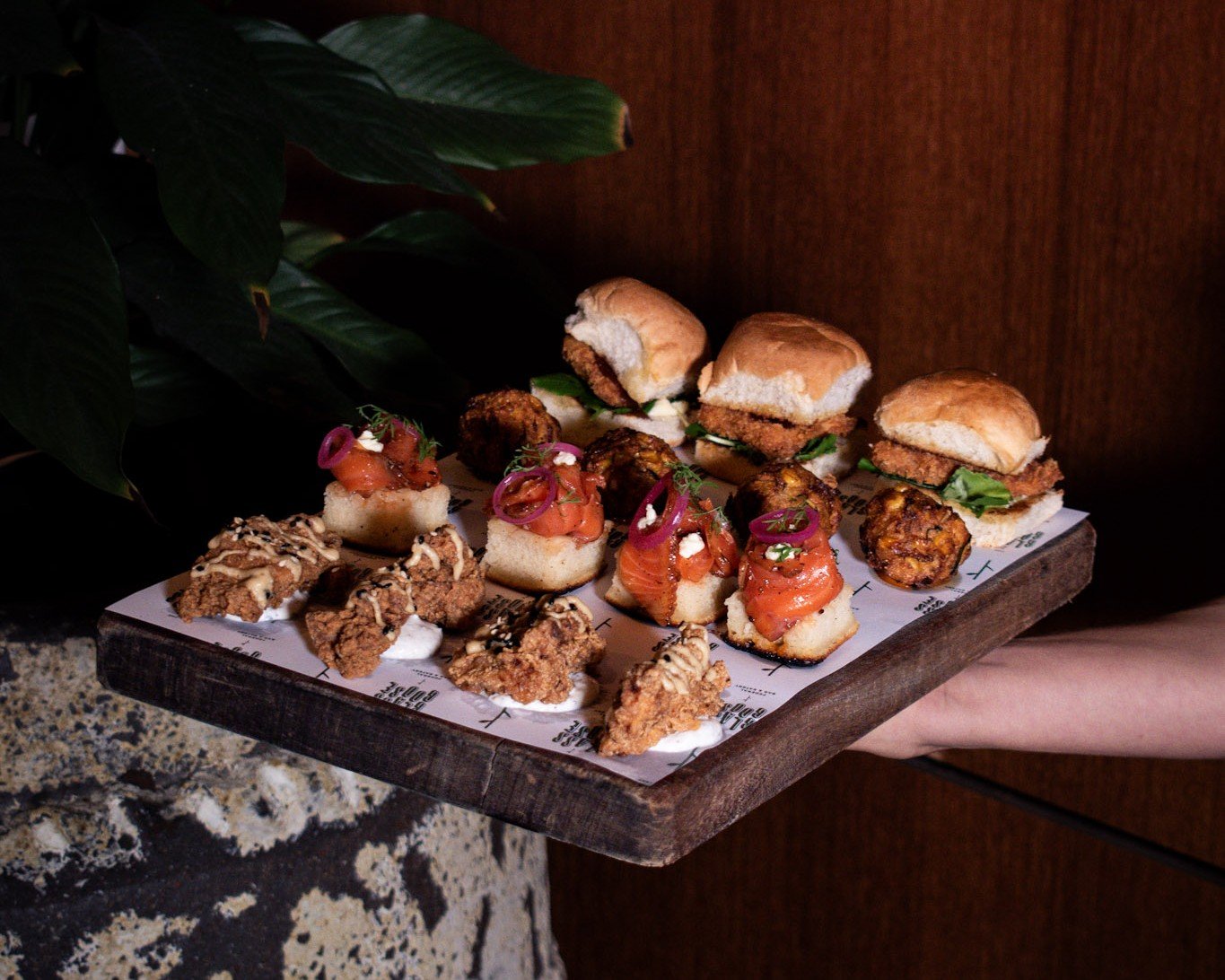 Canapé board of sliders, fried chicken and smoked salmon bites for a corporate event