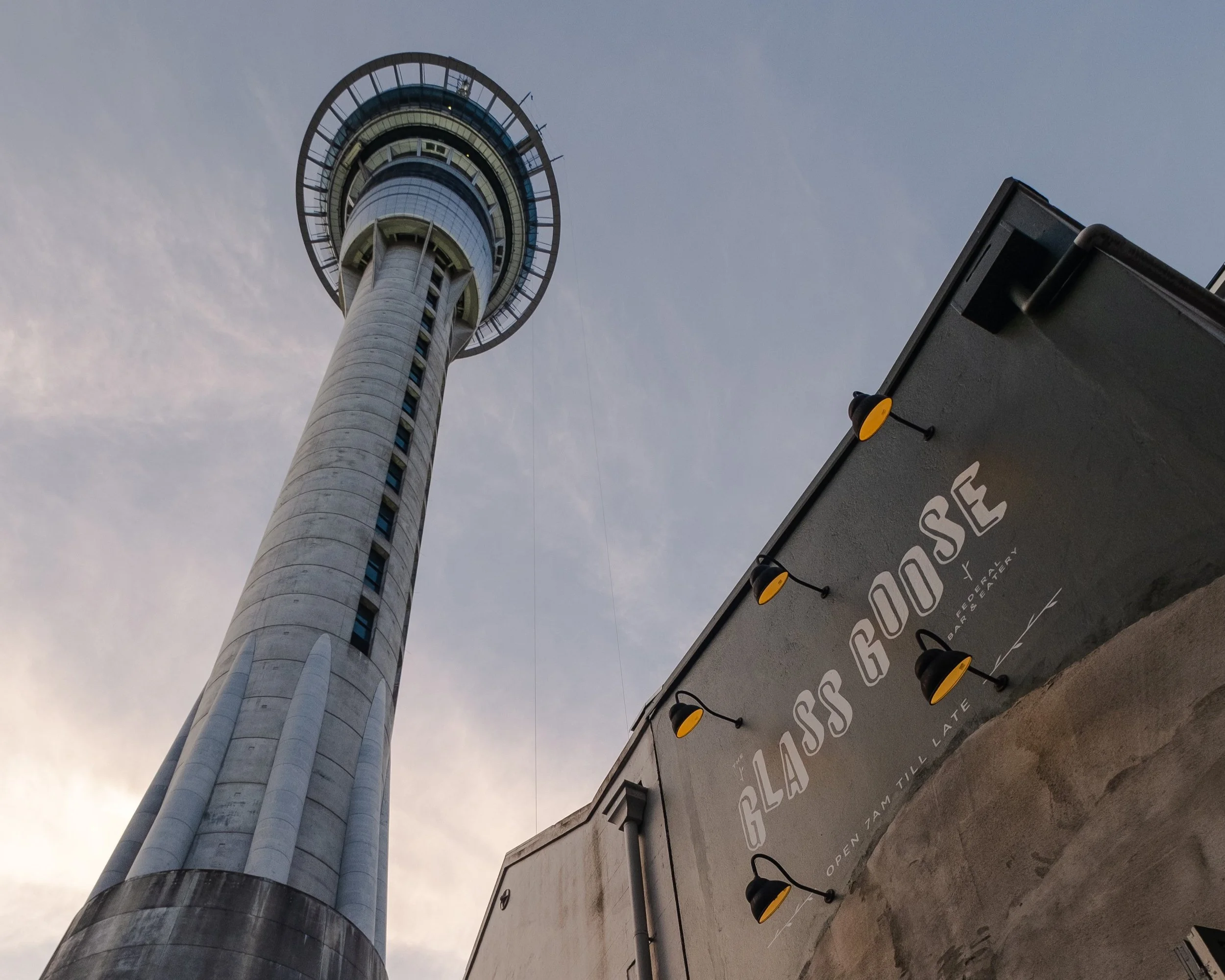 The Glass Goose signage beneath the Sky Tower on Federal Street, Auckland CBD