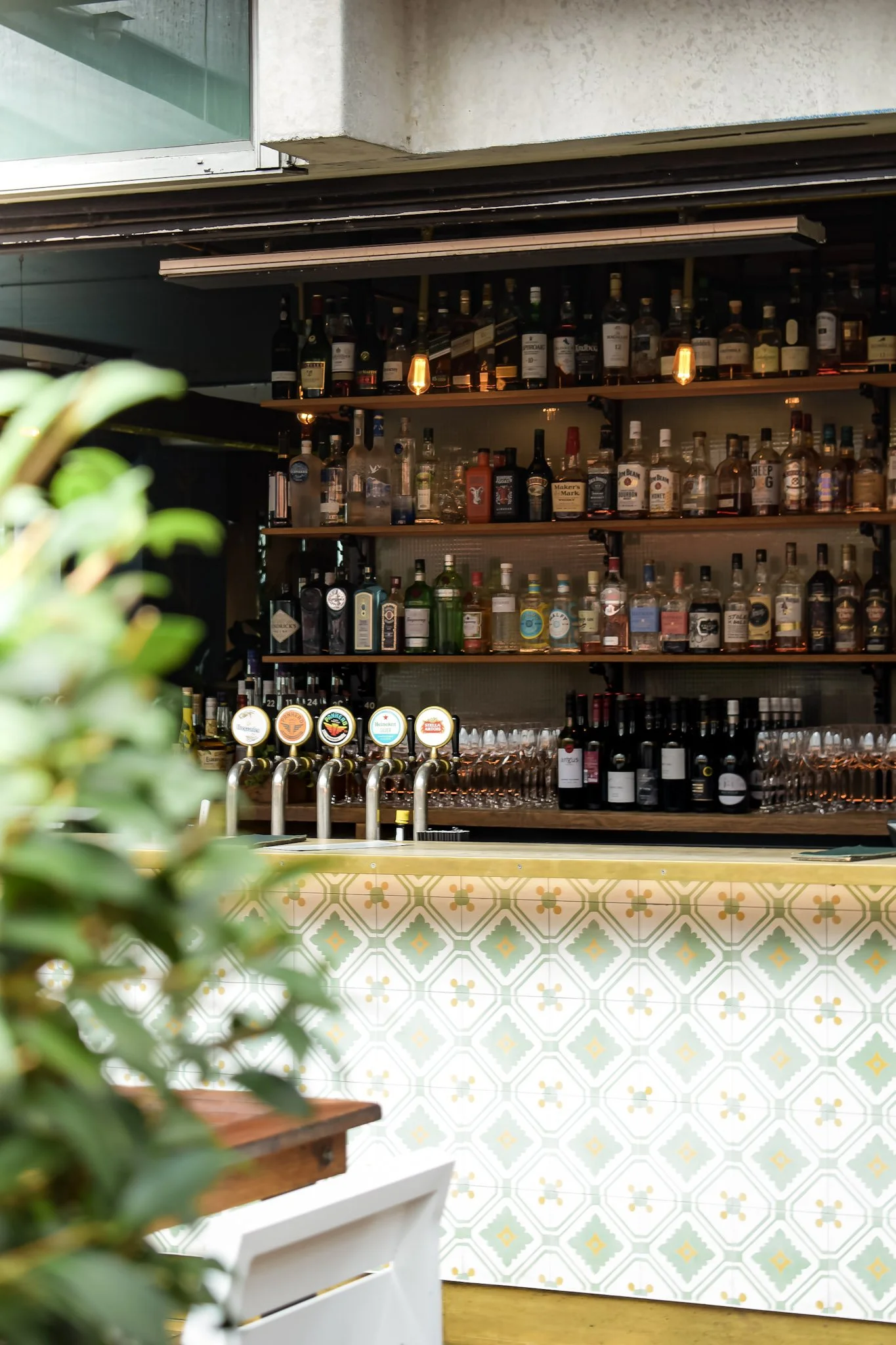 Back bar with spirits, wine and beer taps at The Glass Goose