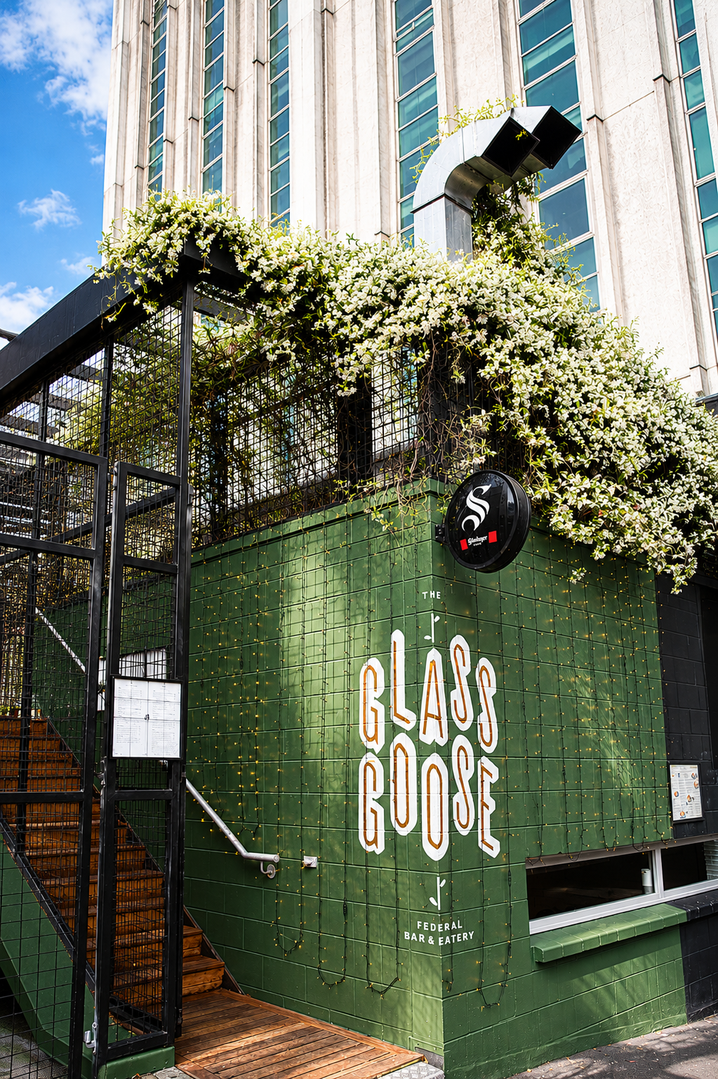 Green flower-covered entrance to The Glass Goose rooftop bar on Federal Street, Auckland CBD