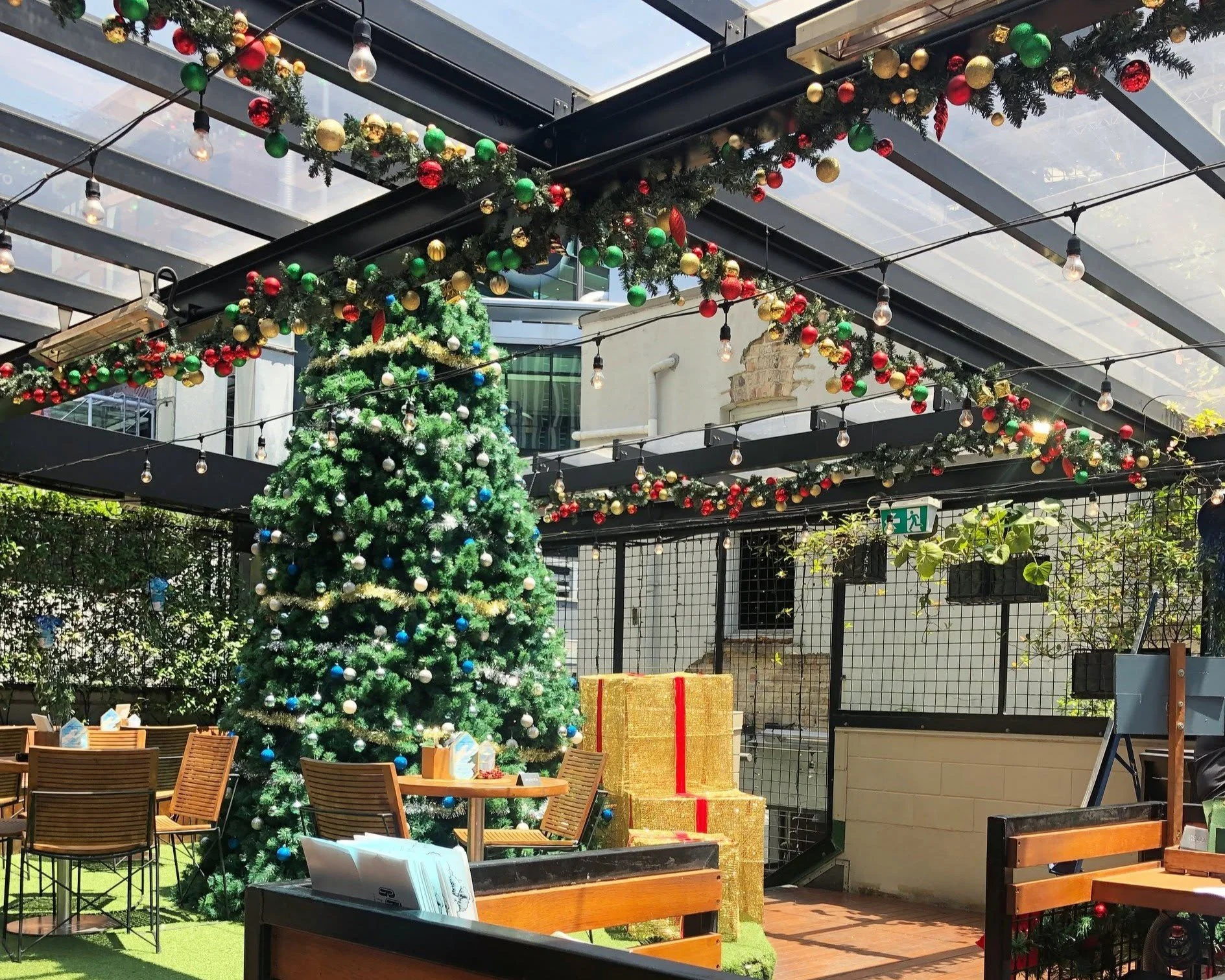 Decorated Christmas tree and gift boxes on the festive rooftop, set for a Christmas party
