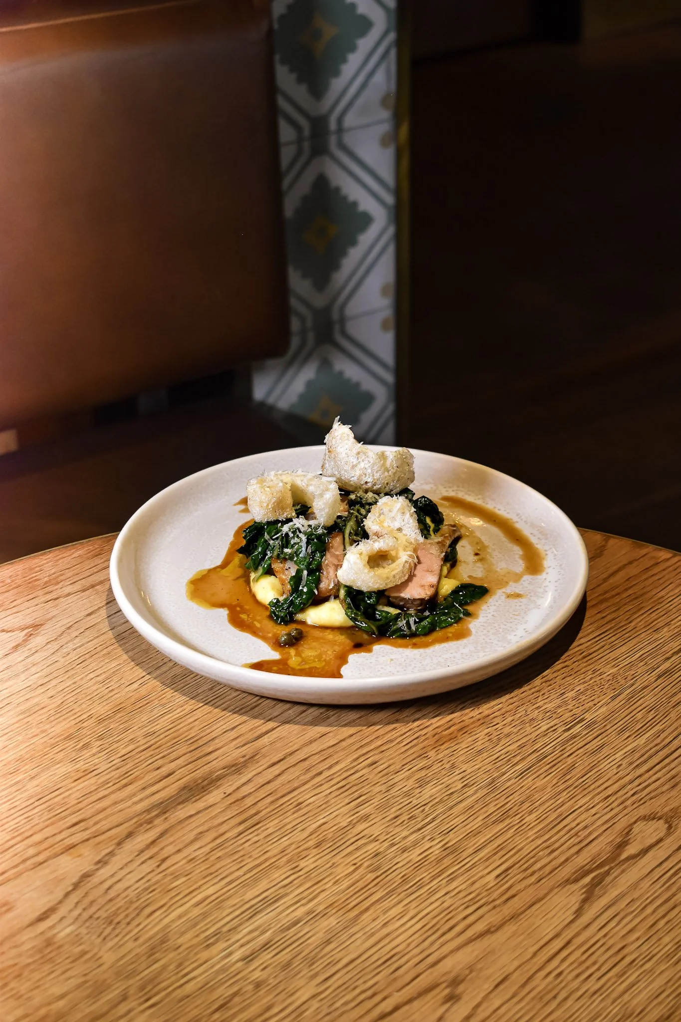 Free-range pork chop with creamy polenta, parsley, lemon brown butter and parmesan at The Glass Goose