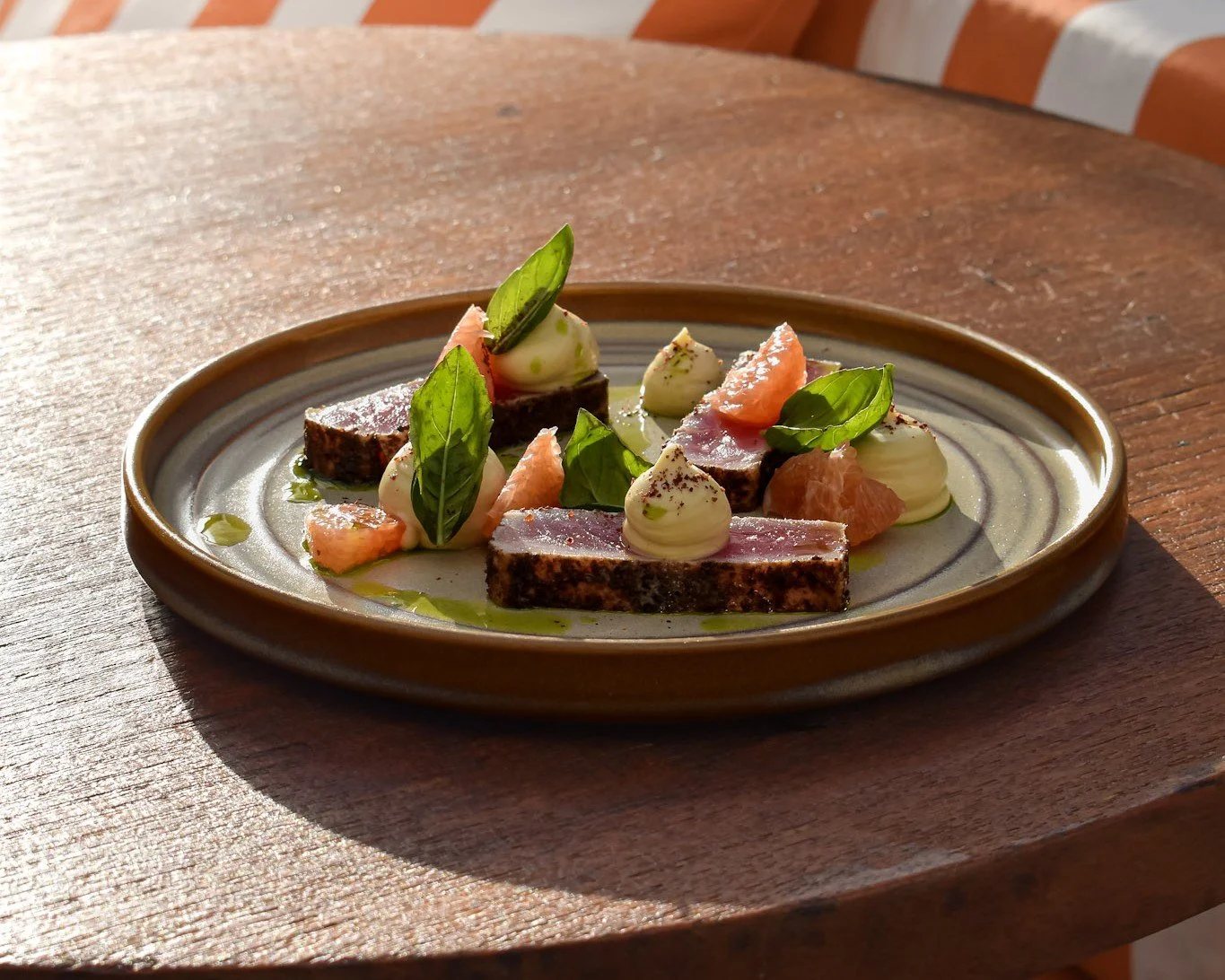 Seared tuna with grapefruit, basil and cream, a plated shared dish