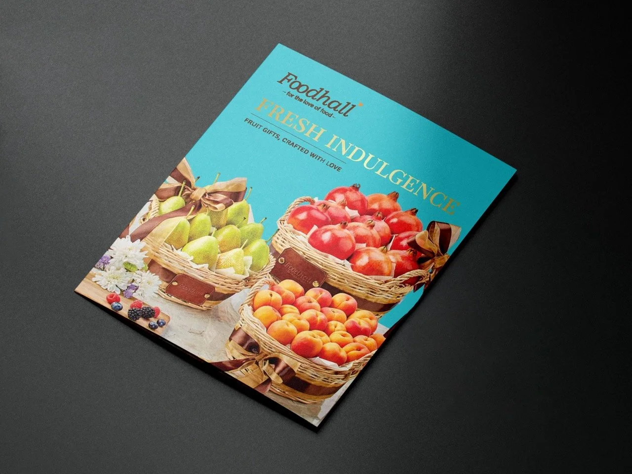 A flyer with a blue background advertising a food market, featuring baskets of fresh apples, peaches, and pears, with some flowers and berries around the baskets.