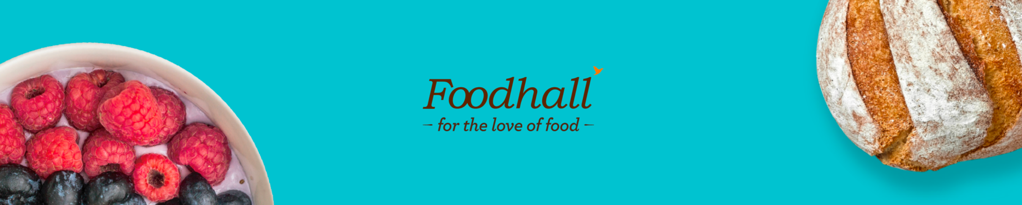 Image of fresh raspberries and blueberries in a white bowl, a loaf of bread on the right, and the text 'Foodhall for the love of food' on a blue background.