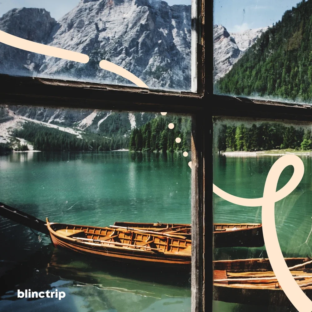 Scenic view of a calm mountain lake with wooden boat, surrounded by forested mountains and snow-capped peaks, seen through a window with decorative white doodles.