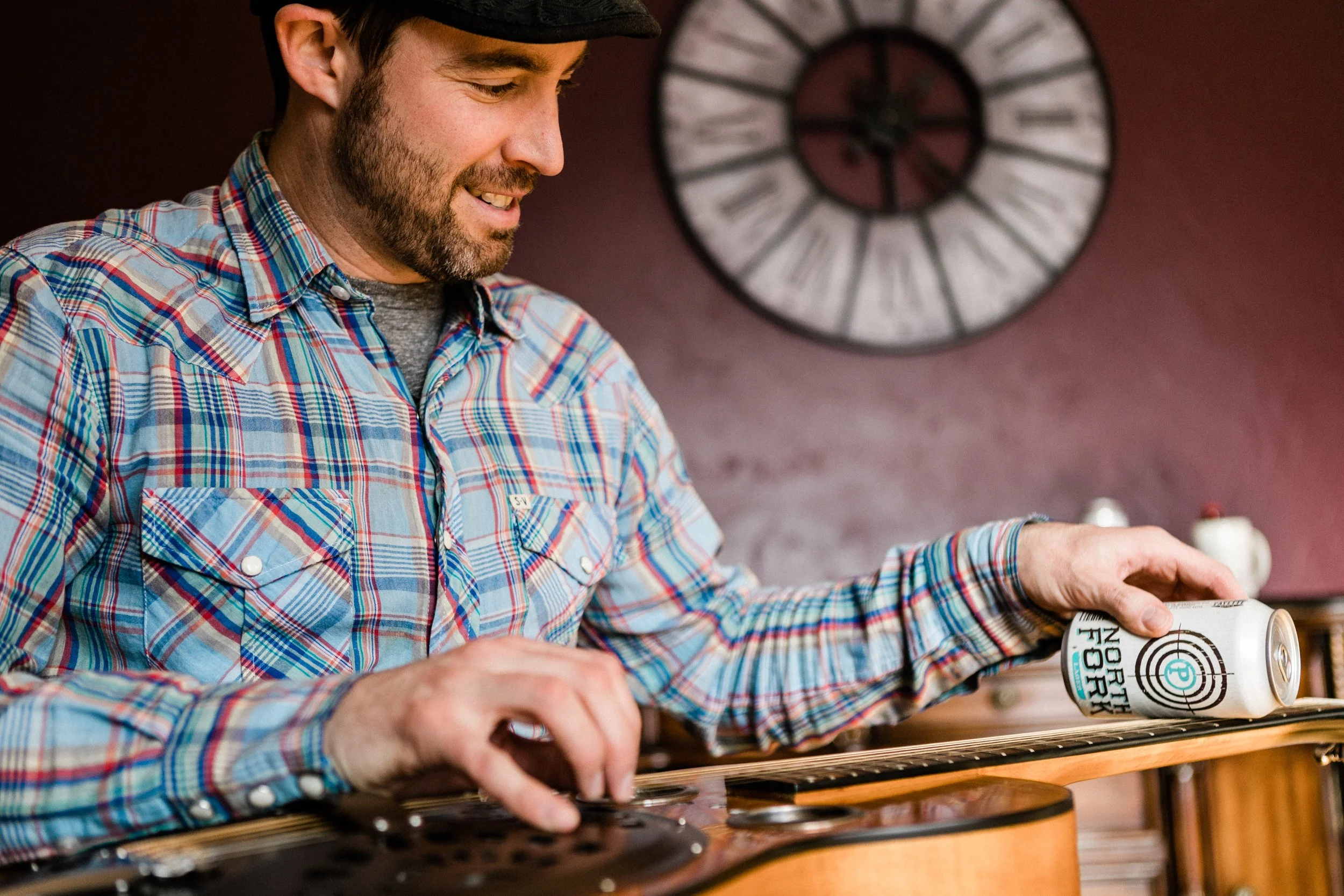 A closeup of music teacher Marcus Marianthi and a guitar at Campfire Music Collective