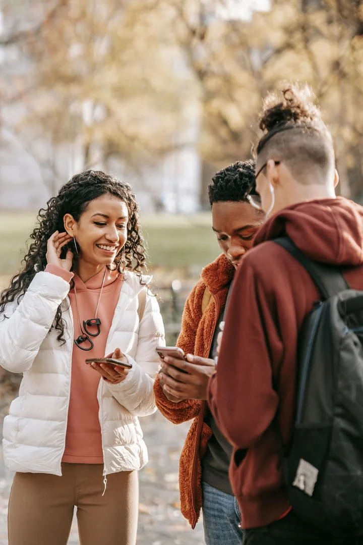 teenagers hanging out, on their phones