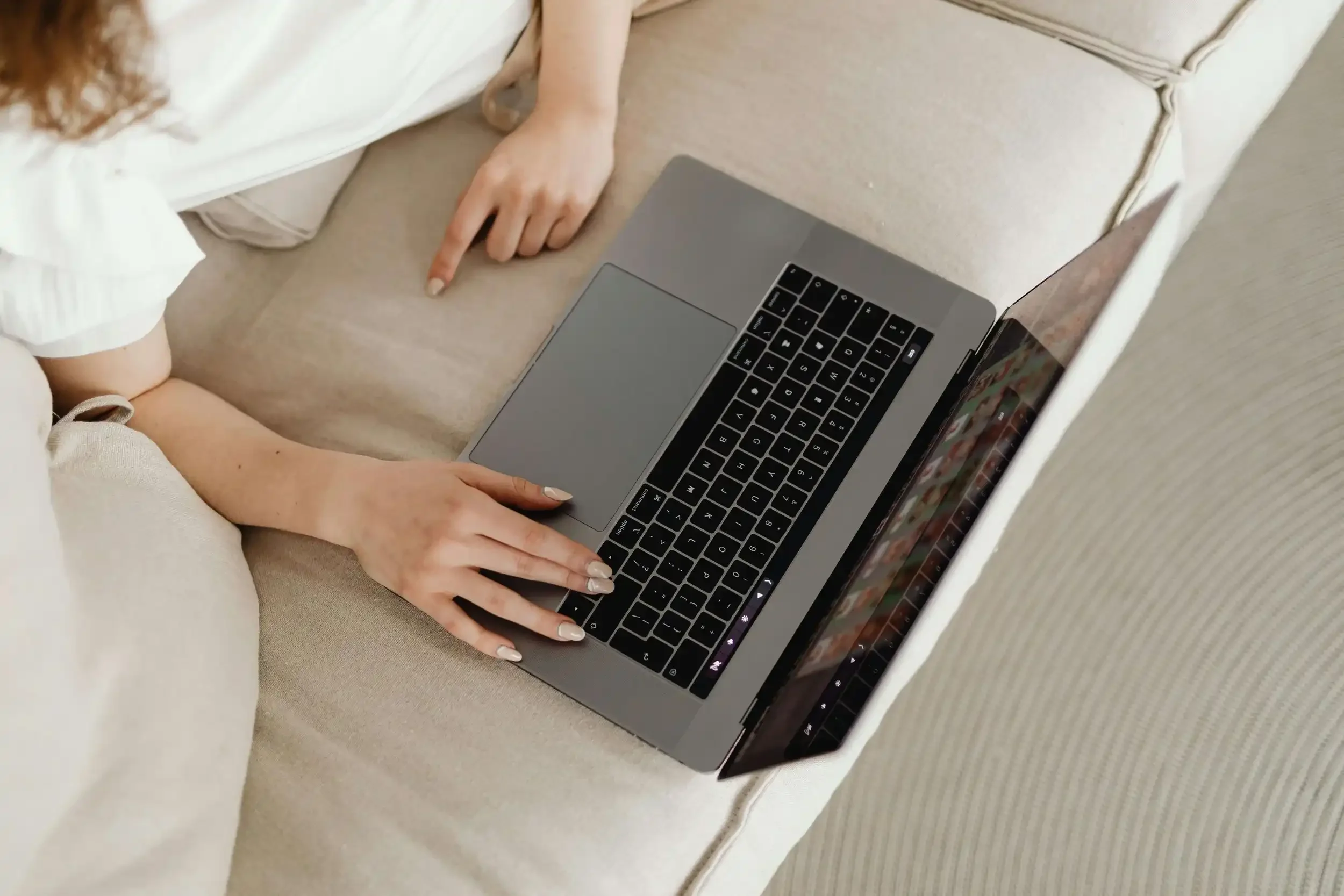 a womans hands using a laptop
