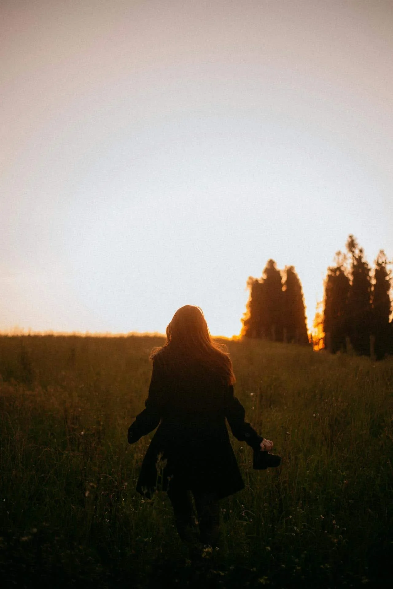 teen in field at sunset