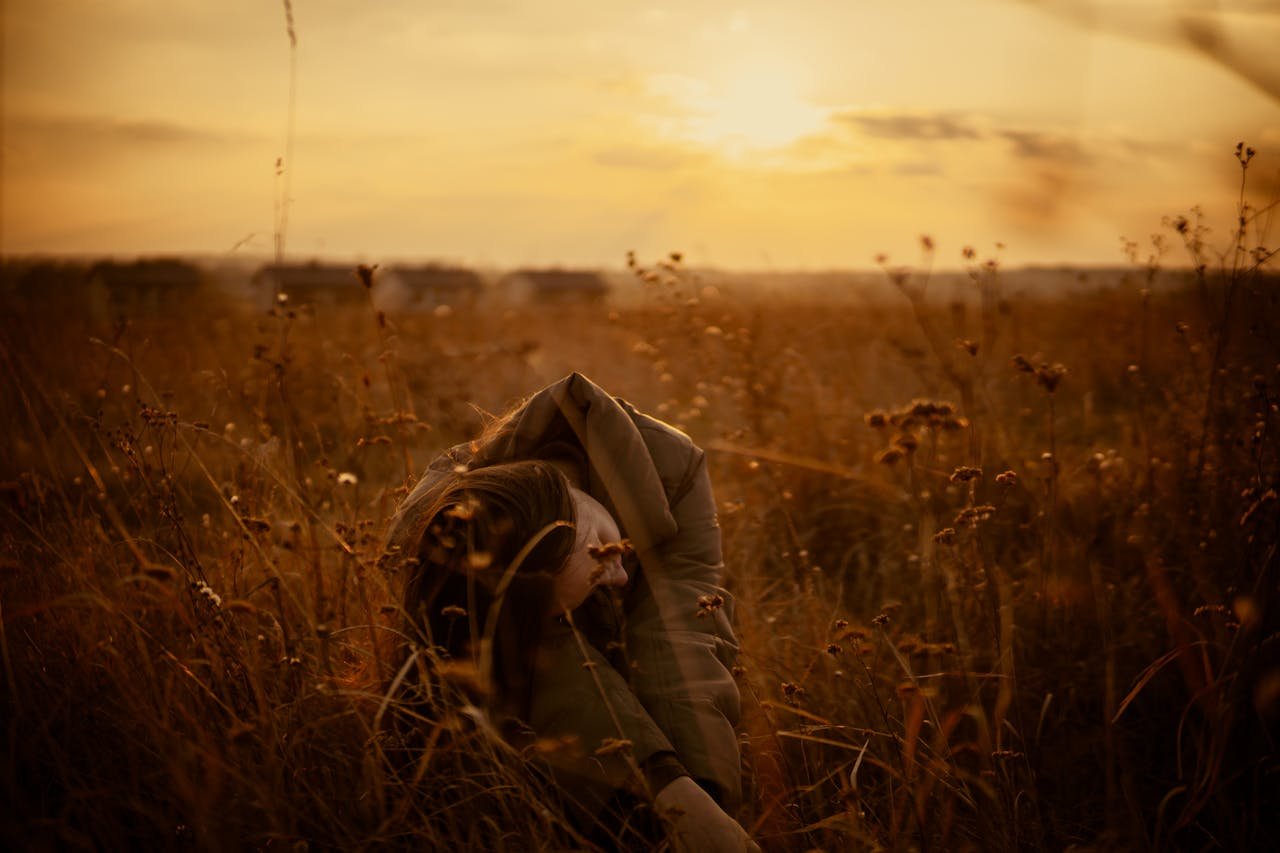 sepia photo of woman in wheat field