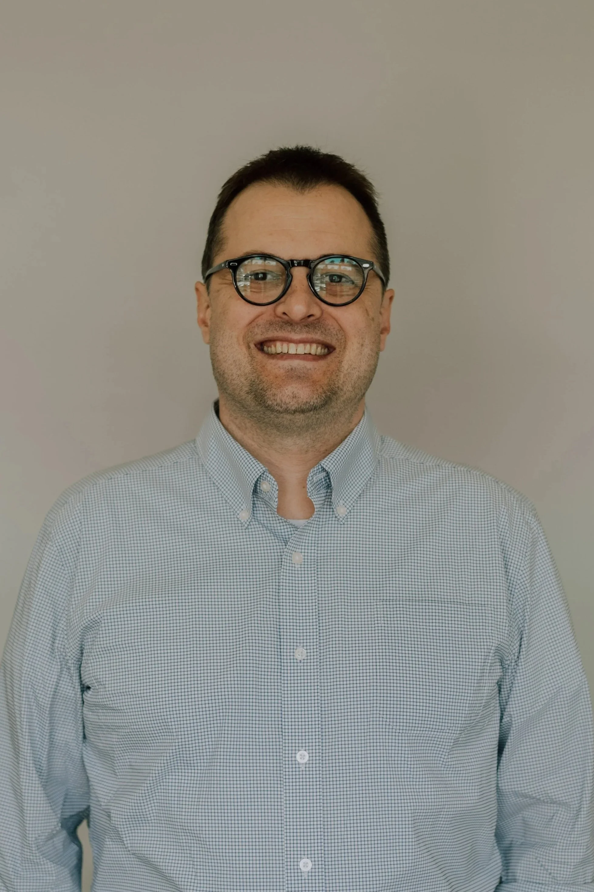 david fisk, a man smiling with glasses and a blue shirt