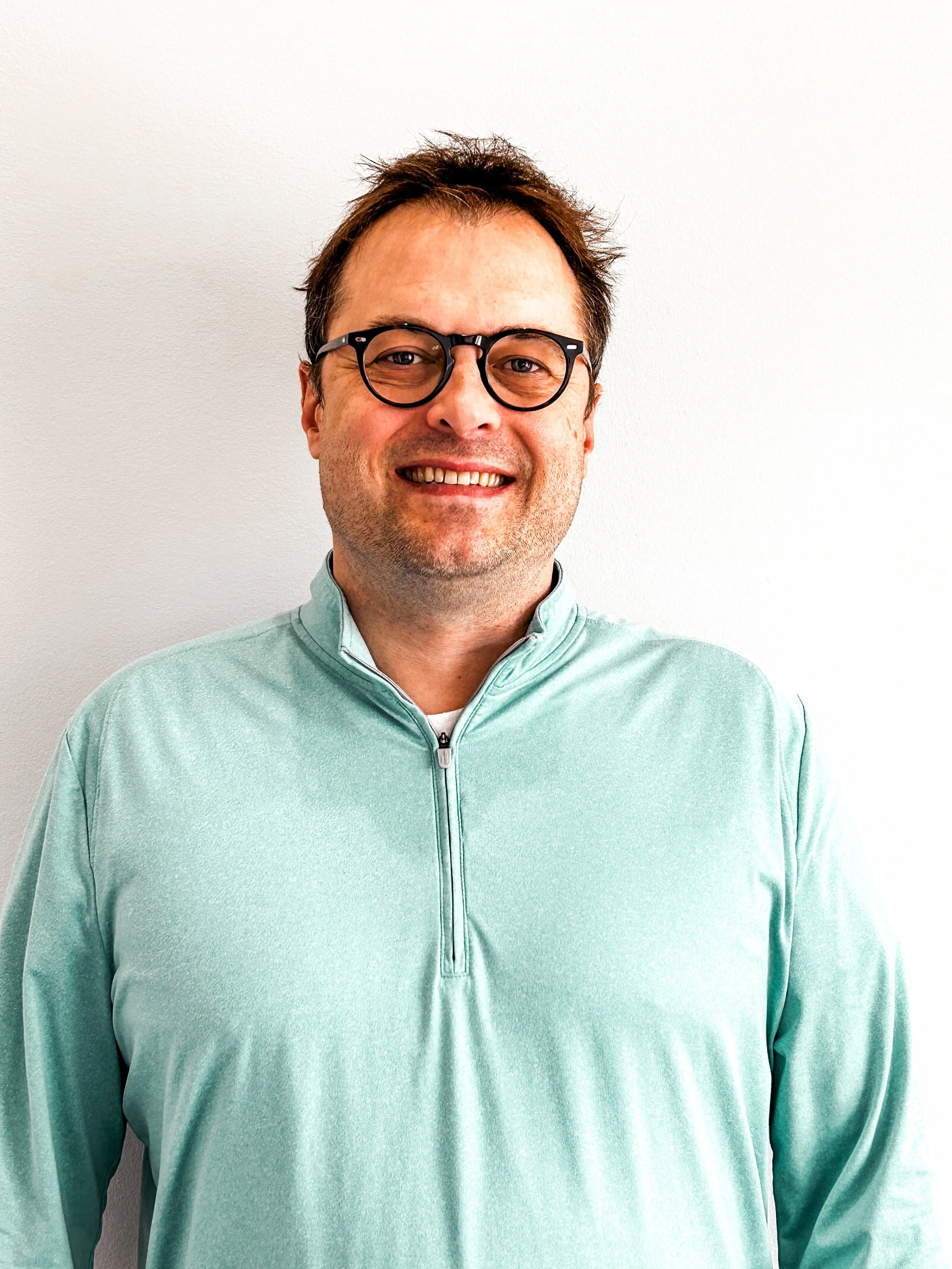 david fisk, a man smiling with glasses and a blue shirt