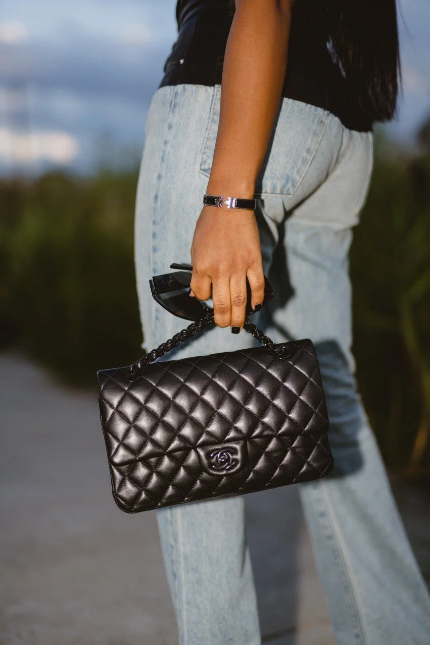 Detail shot of Kaniya J's outfit, jewelry and hands
