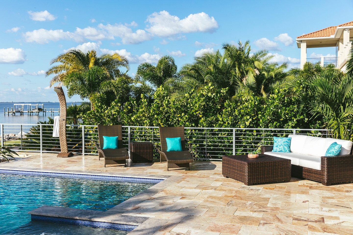 This June, we&rsquo;re all about outdoor lounging🌴 This Florida home we designed features our choices of woven lounge chairs and blue pillows that echo the cool tones of Tampa&rsquo;s coastal waters. #SummerExteriors #LoveToLounge #lornagrossinterio