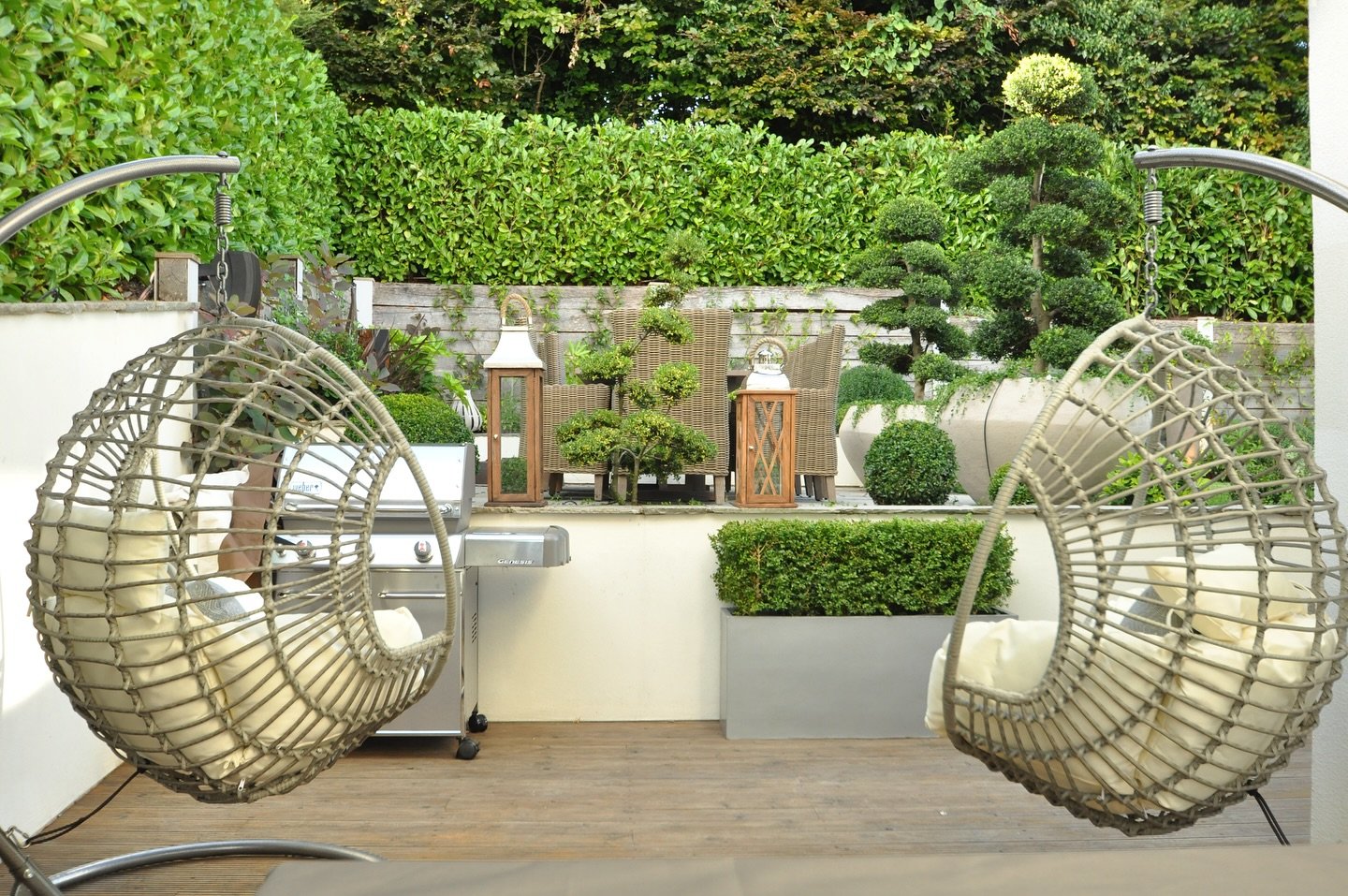 This outdoor lounge we designed for a London home invites you to unwind in comfort. Nesting chairs and natural greenery create a serene space to sit back and enjoy the view!  #LoveToLounge 🌿#lornagrossinteriordesign #LornaGrossDesigns #SummerExterio