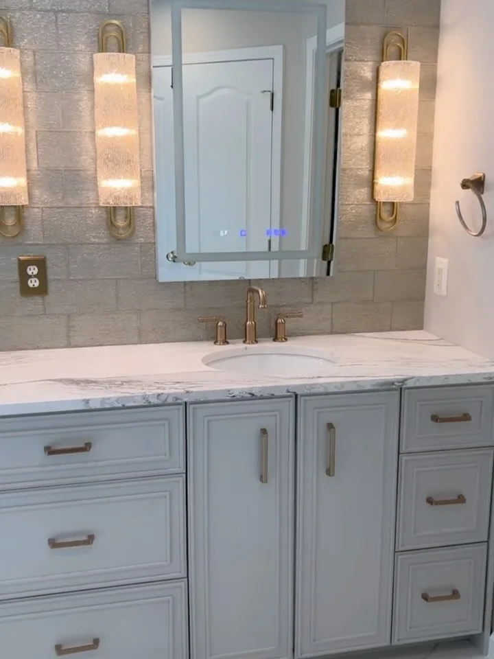 There&rsquo;s nothing like a renovated bathroom. Glowing vanity lighting and layered wall details turn a simple space into a luxurious sanctuary for calm and care.🪞

#lornagrossinteriordesign #bathroomrenovation #lornagross #dmvinteriordesigners