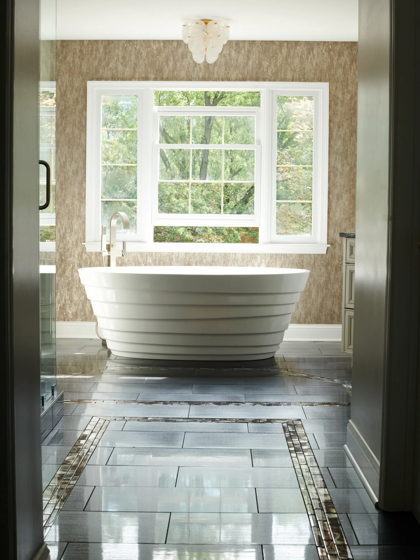 This bathroom was designed to feel regal&mdash;natural light pours in, perfectly highlighting the porcelain tub at the heart of the space🩵

#lornagross #lornagrossinteriordesign #bathroomdecor #InteriorInspo