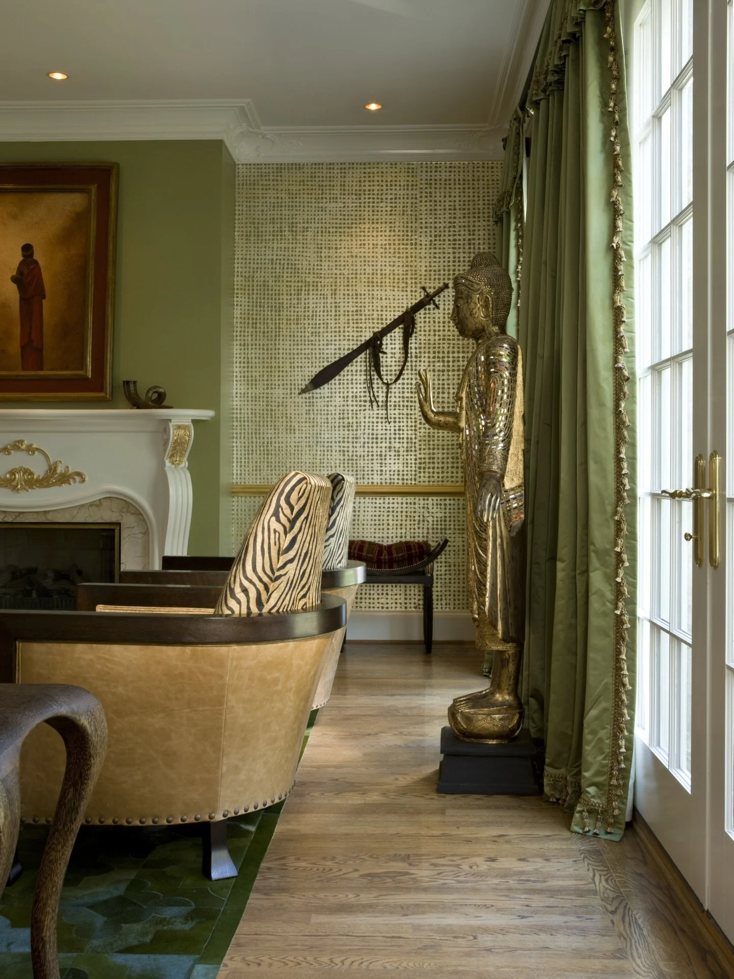 Designed to echo the beauty of the natural world, this living room brings the outdoors in through a calming palette of greens and warm tans. Layered textures and subtle animal prints add a sense of movement and adventure, creating a space that feels 