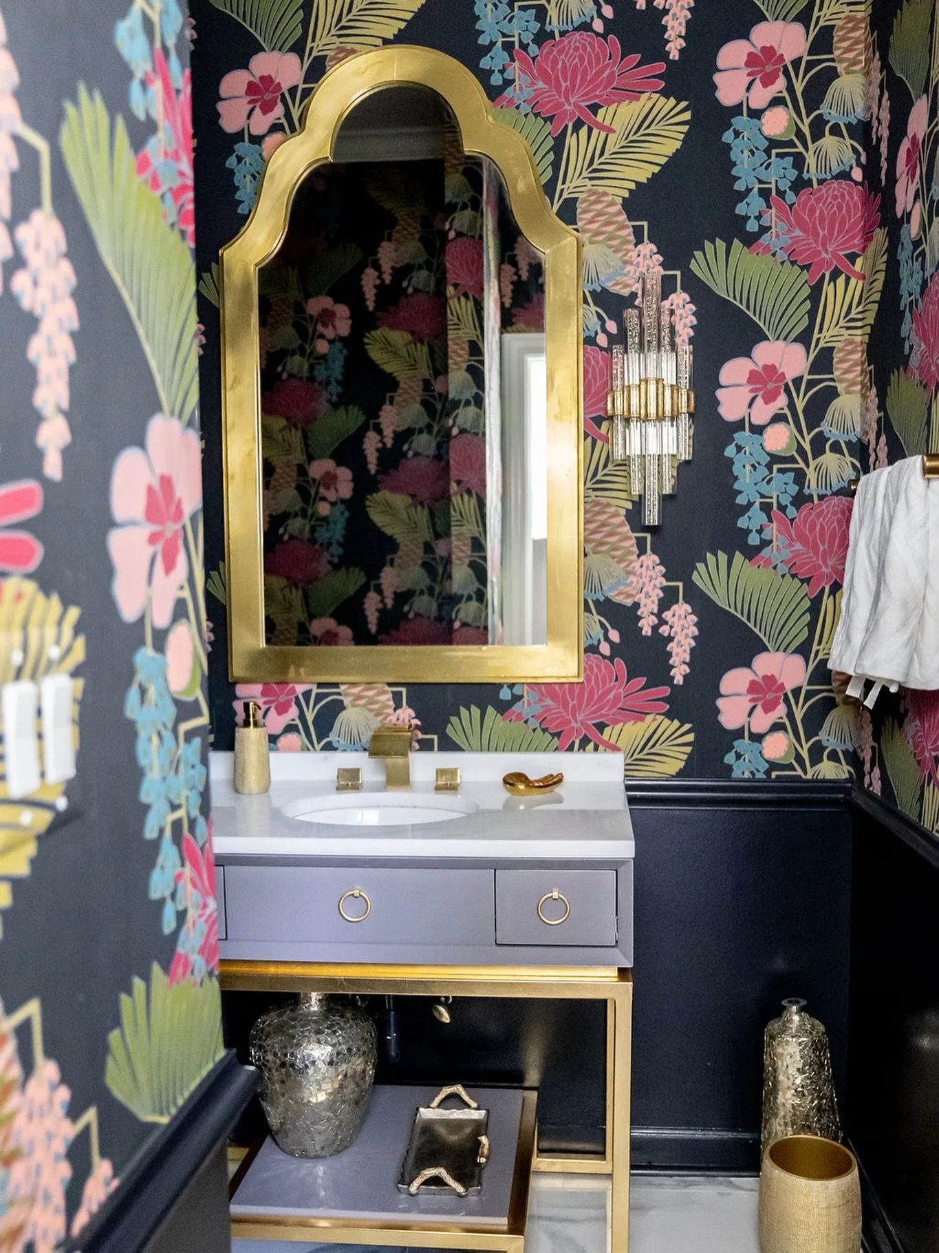 Lorna&rsquo;s signature style shines through her love of wallpaper. This bathroom comes alive with vibrant floral patterns that wrap the space in color and charm, while the gold-trimmed features adds a touch of luxury to the fresh spring-inspired des